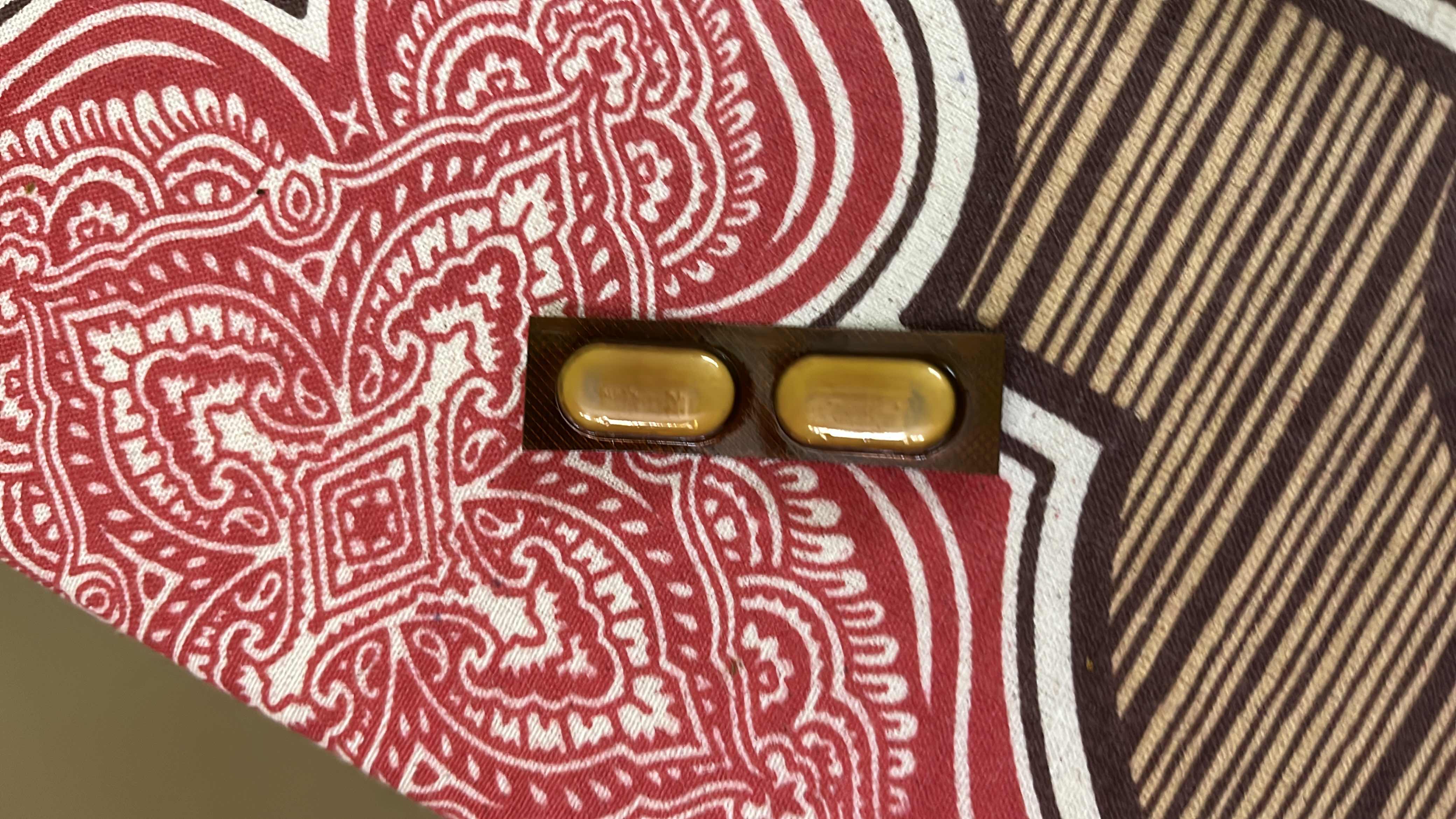 The image shows two capsules, which are likely supplements or medication, and do not contain nutritional information typically associated with food.