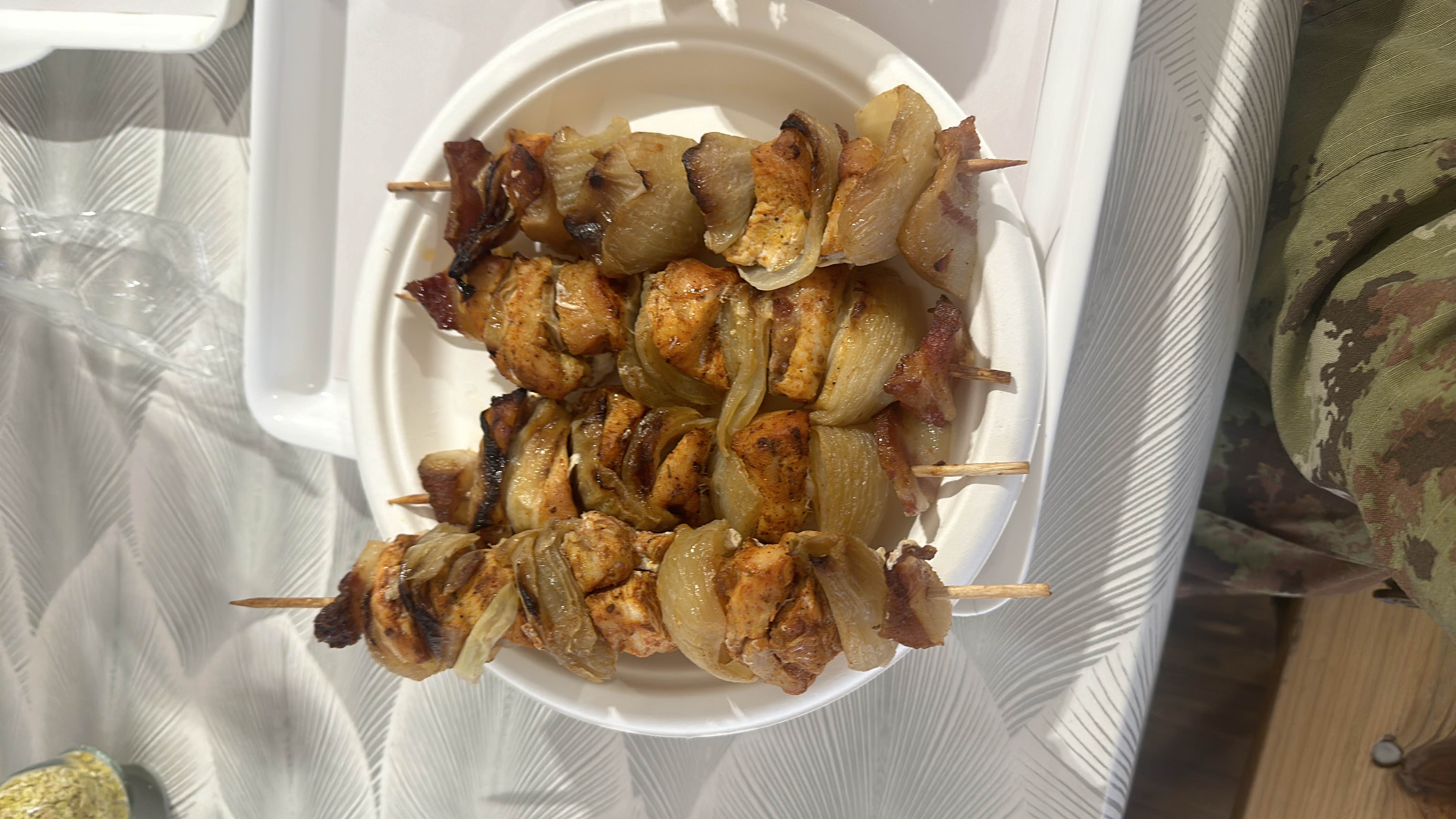 Grilled chicken skewers with onions and bacon, providing a balanced mix of protein, fats, and minimal carbs.