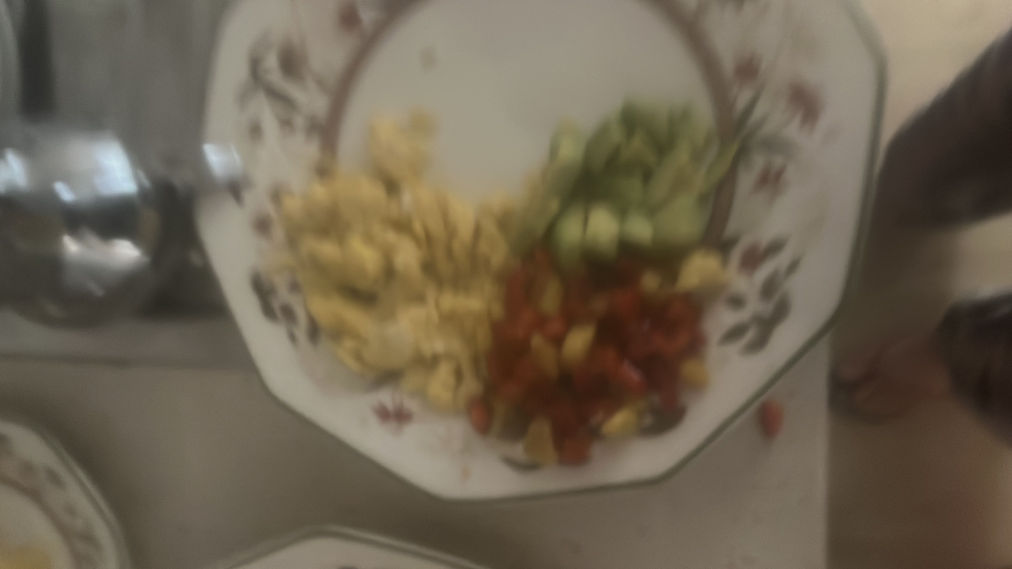 A plate containing scrambled eggs, cucumber slices, and diced tomatoes, offering a balanced mix of protein, fats, and carbs.