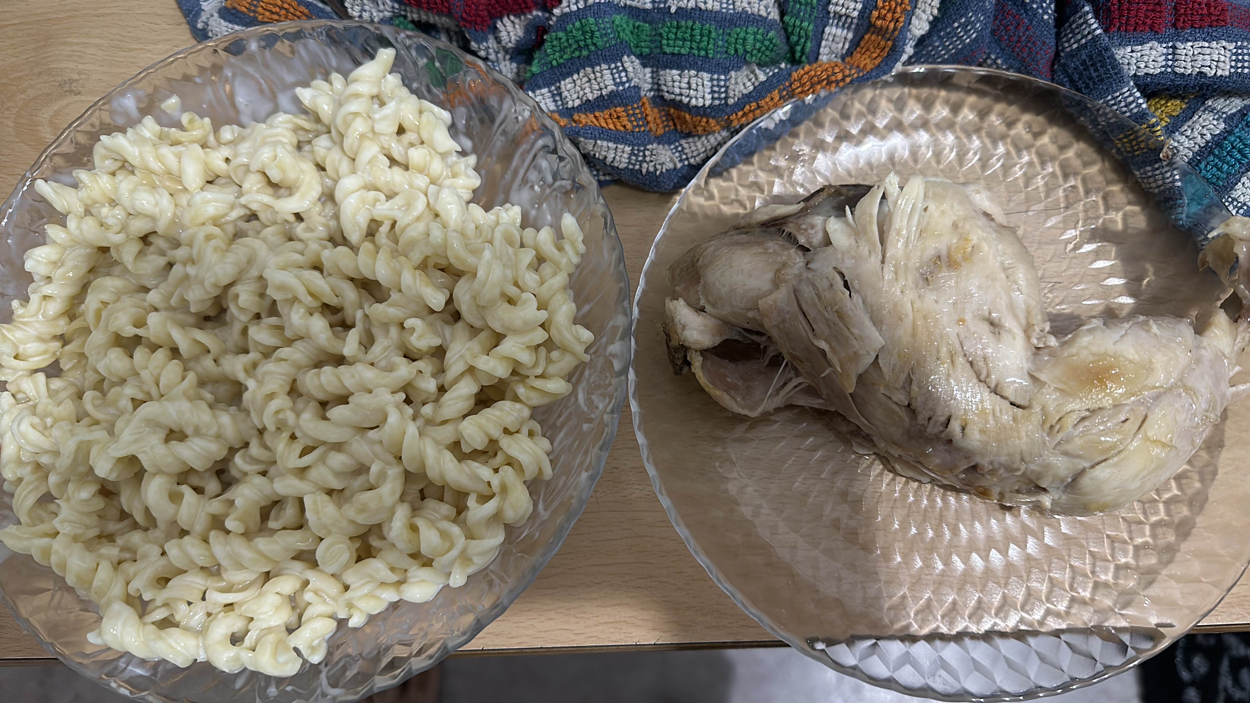 A meal consisting of cooked chicken and creamy pasta, providing a balanced mix of protein, carbohydrates, and fats.