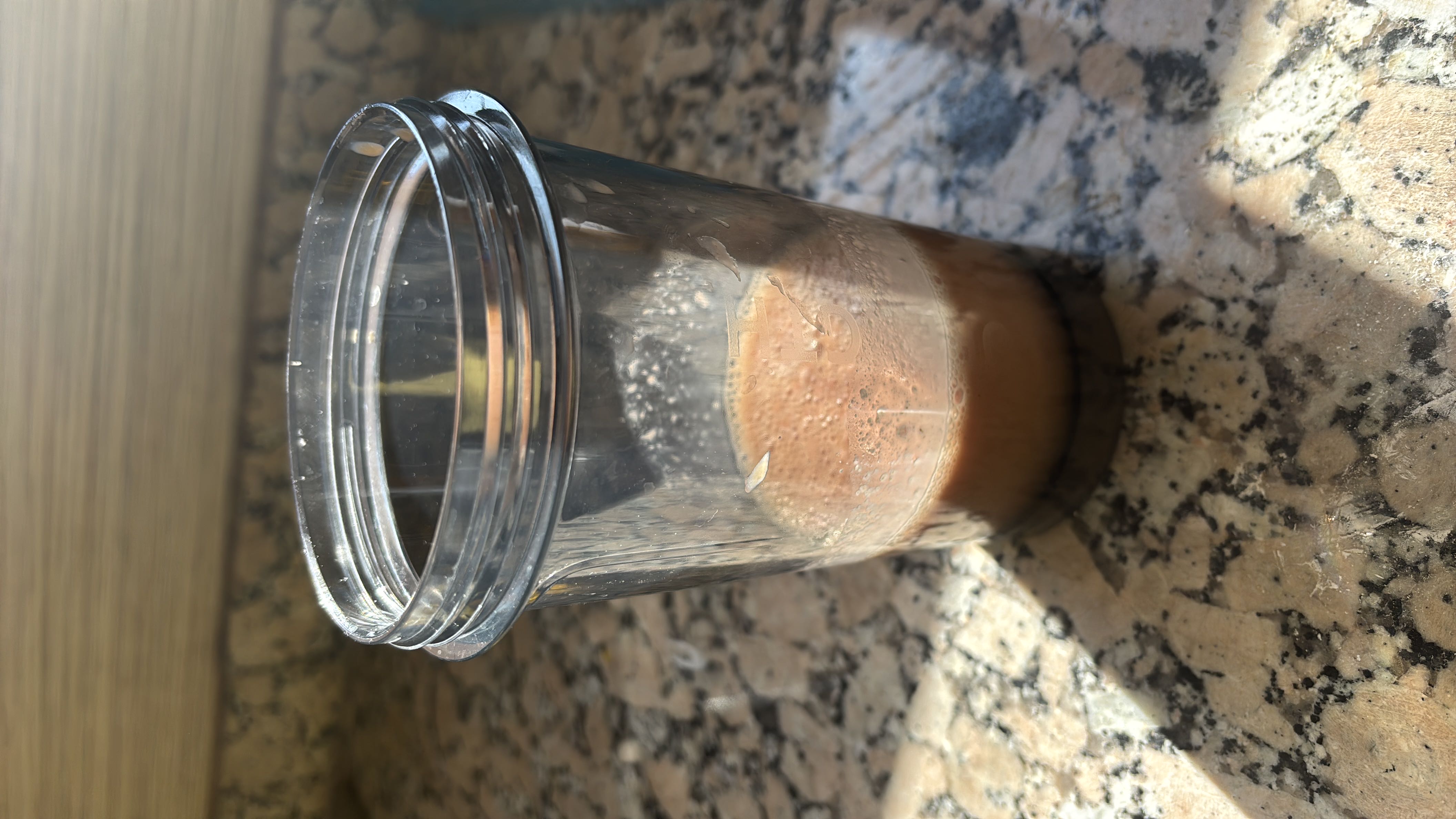 A small portion of chocolate milk in a transparent container, providing a moderate amount of calories and nutrients.