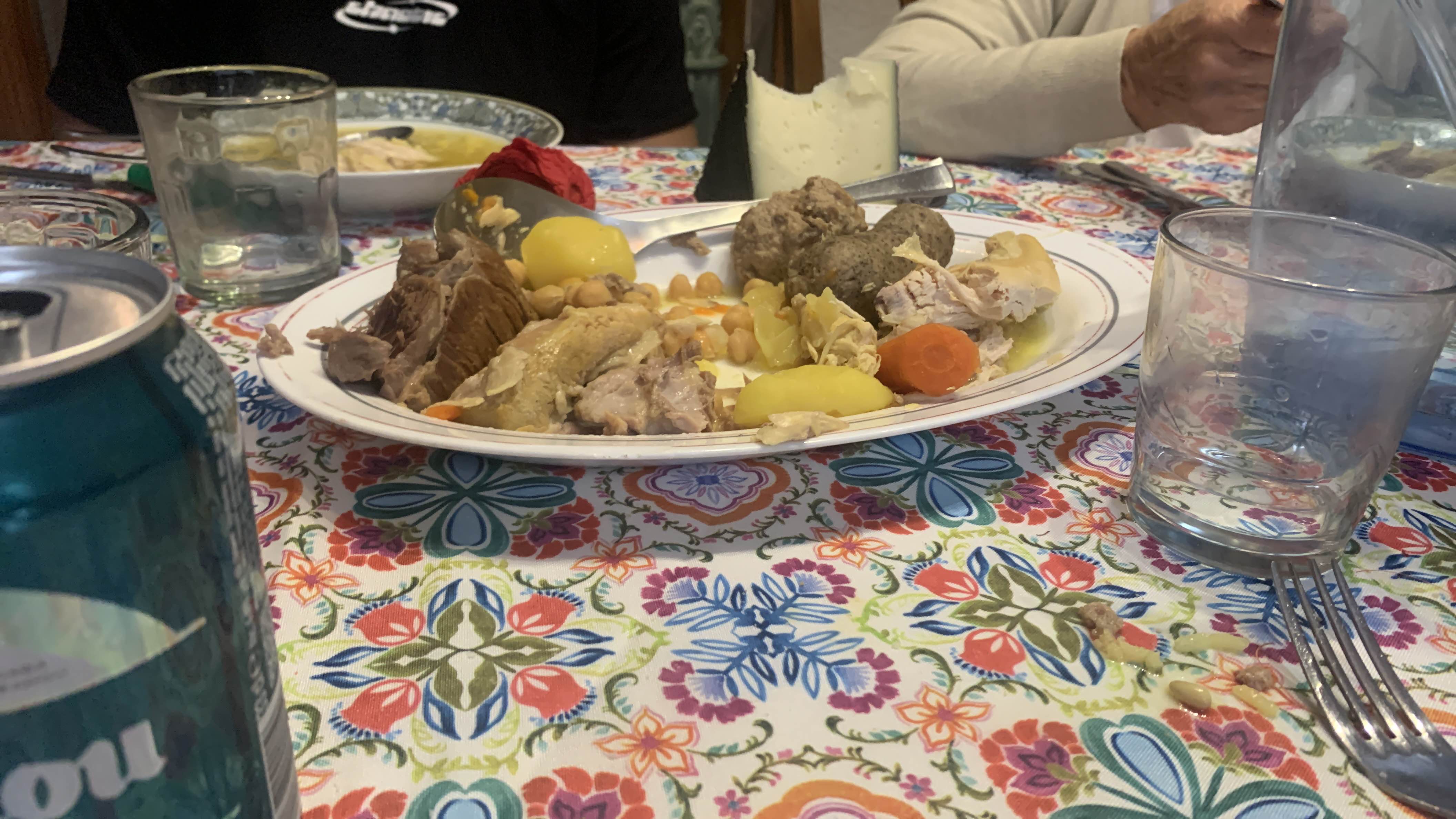 A hearty dish featuring chicken, potatoes, carrots, chickpeas, and meatballs, providing a balanced mix of protein, carbs, and fats.