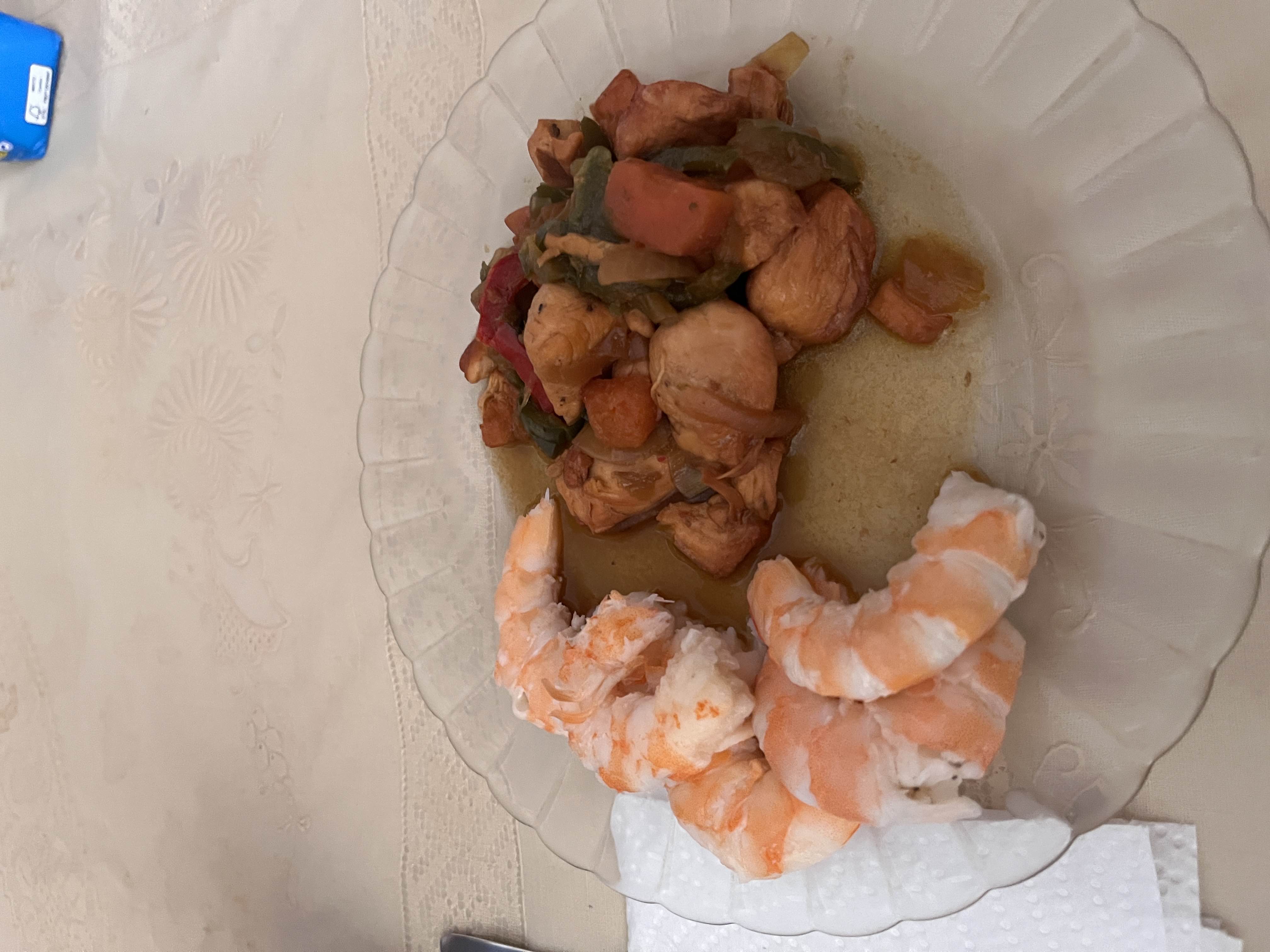 A plate containing shrimp, chicken, and mixed vegetables, providing a high-protein, low-carb meal.