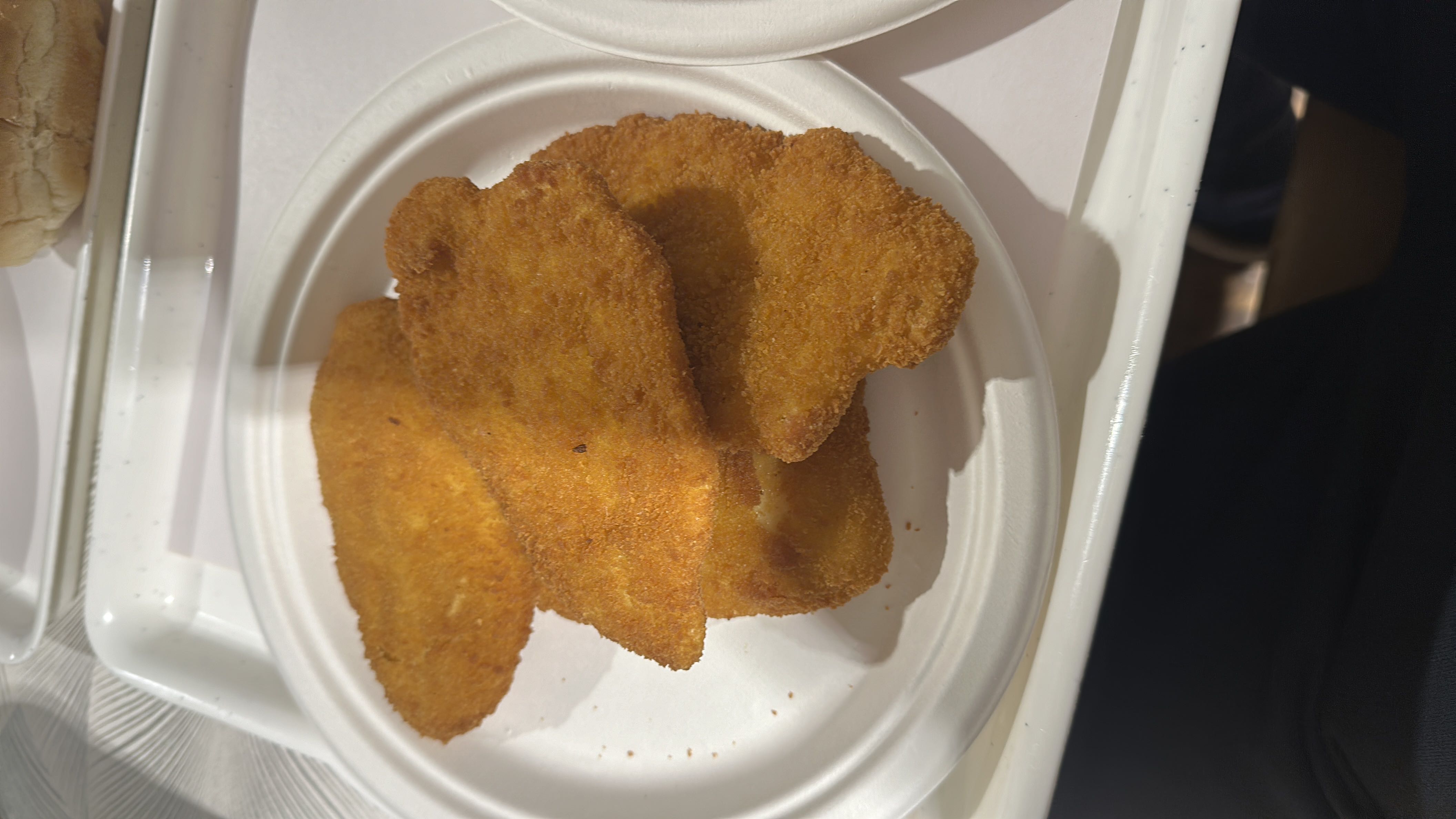 A plate of breaded and fried chicken fillets, providing a moderate balance of protein, carbs, and fats.