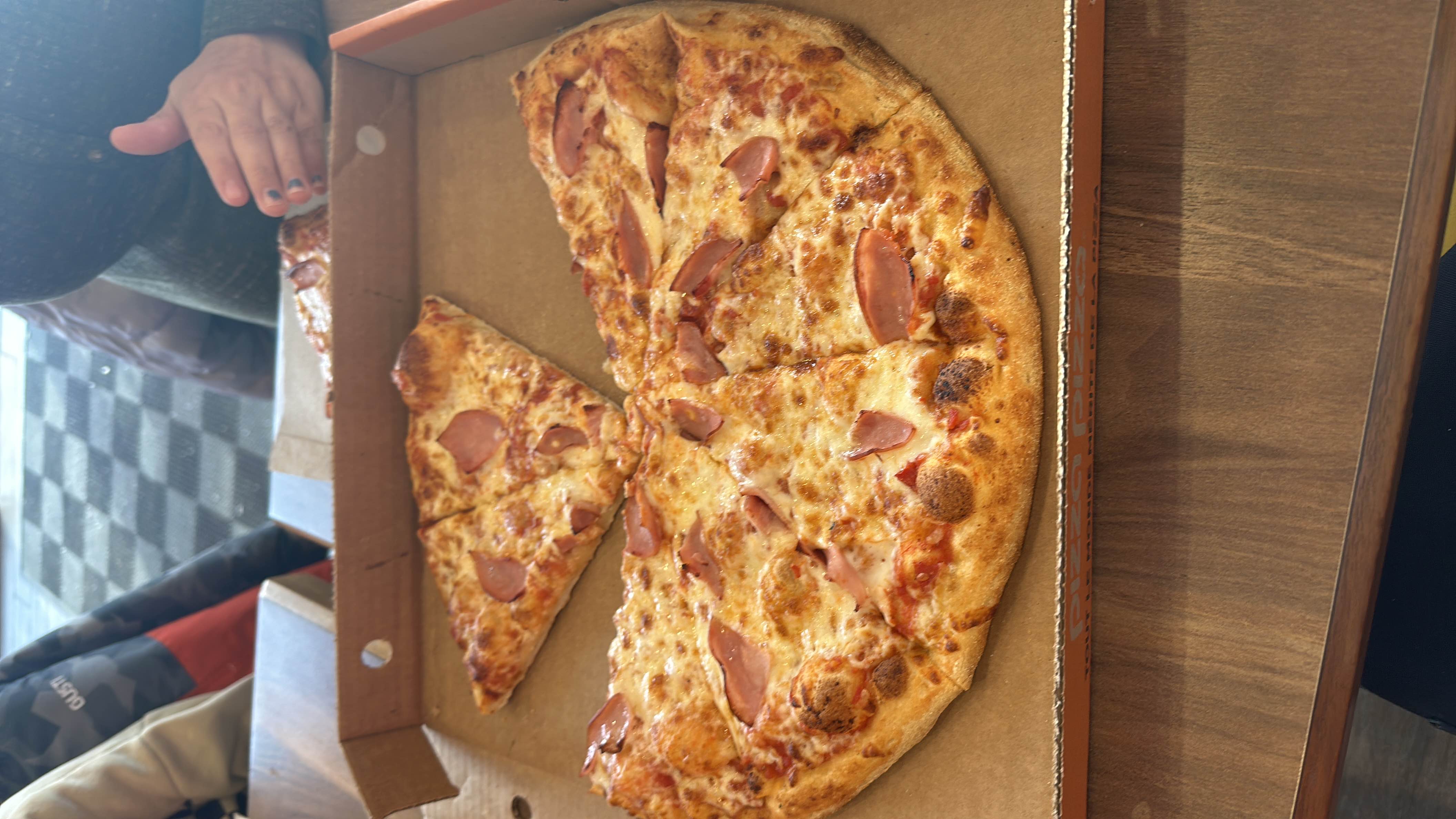 A ham and cheese pizza with a crispy crust, providing a balanced mix of protein, carbs, and fats.