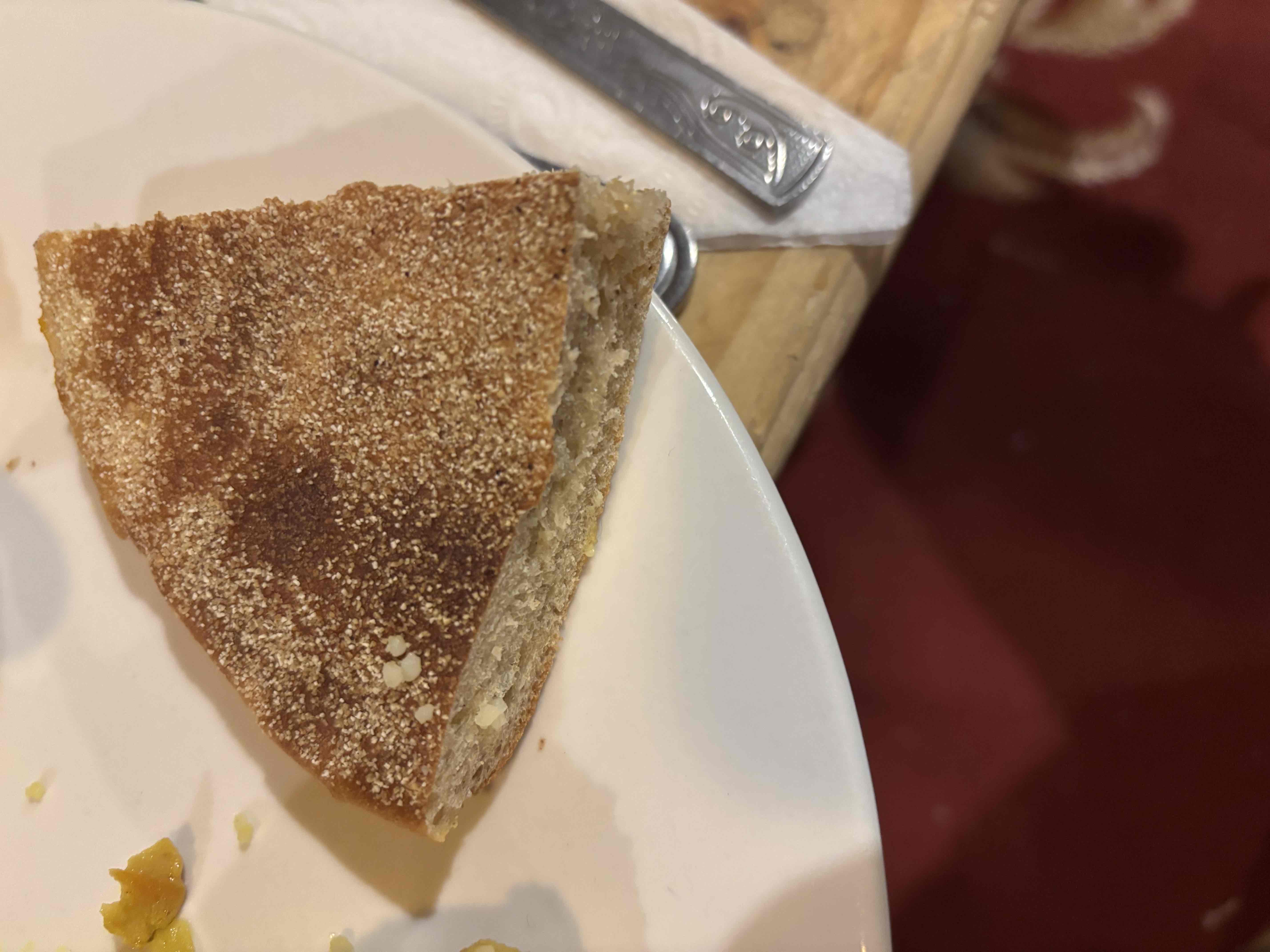 A slice of semolina bread, lightly toasted, providing moderate calories and carbohydrates with minimal fats.