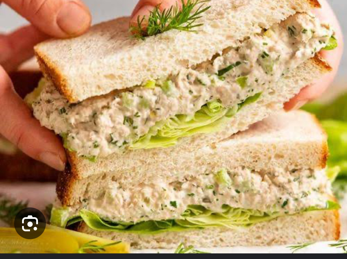 A tuna salad sandwich with lettuce on whole-grain bread, providing a balanced mix of protein, carbs, and fats.
