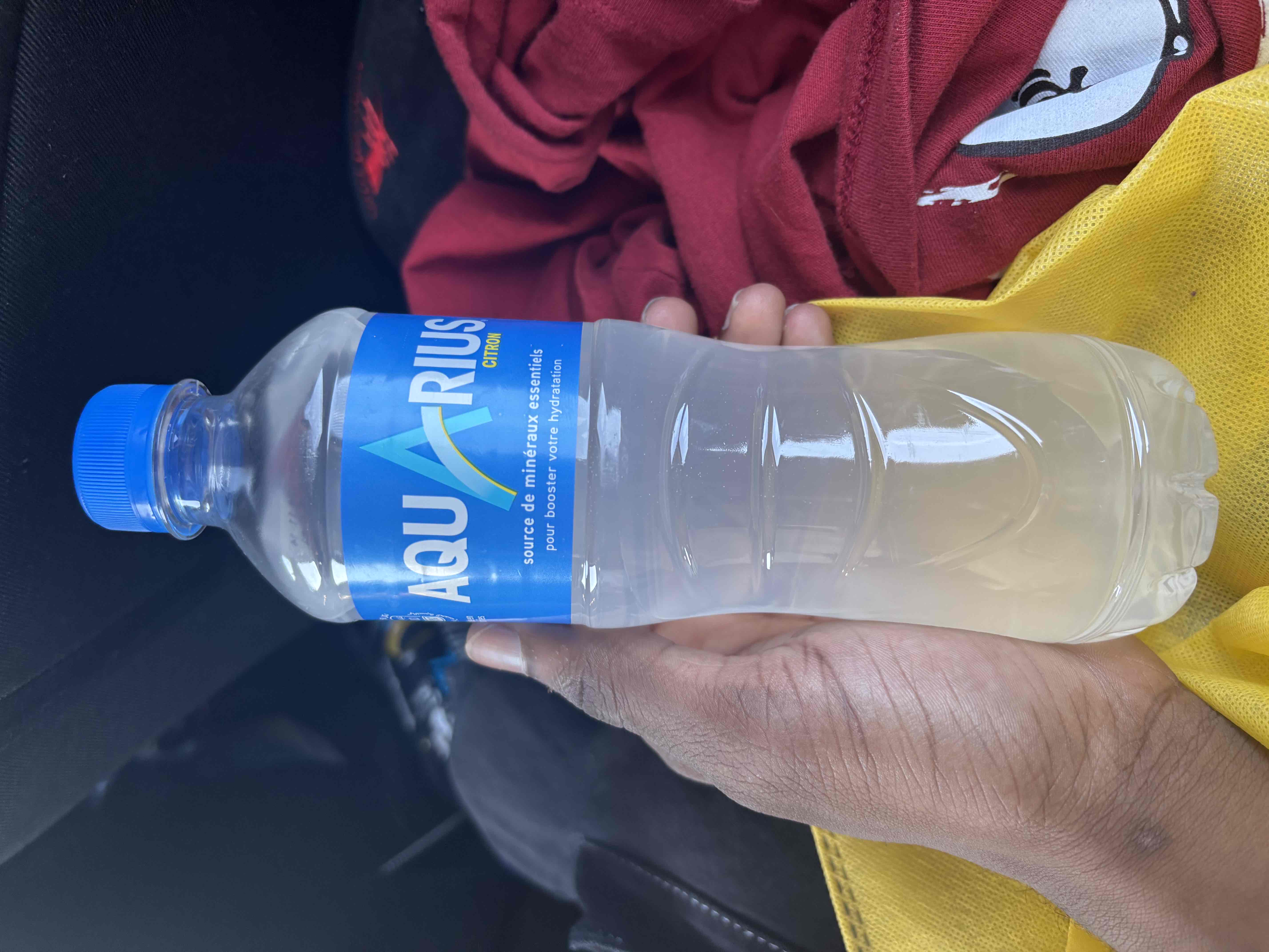 A bottle of Aquarius Citron, a hydration beverage with essential minerals and no significant calories, protein, carbs, or fats.