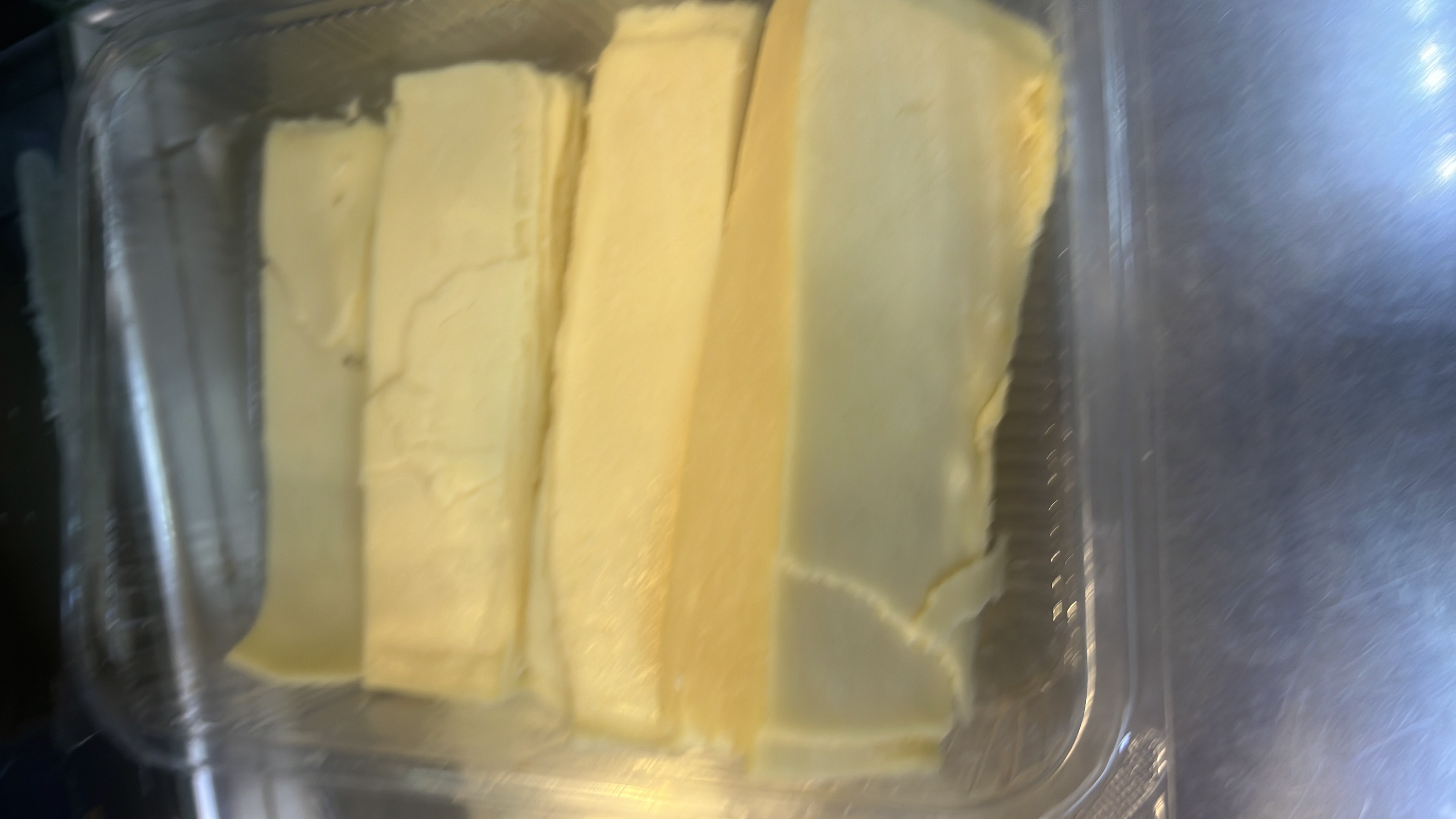 The image shows slices of butter, which is high in fats and calories with minimal protein and no carbohydrates.