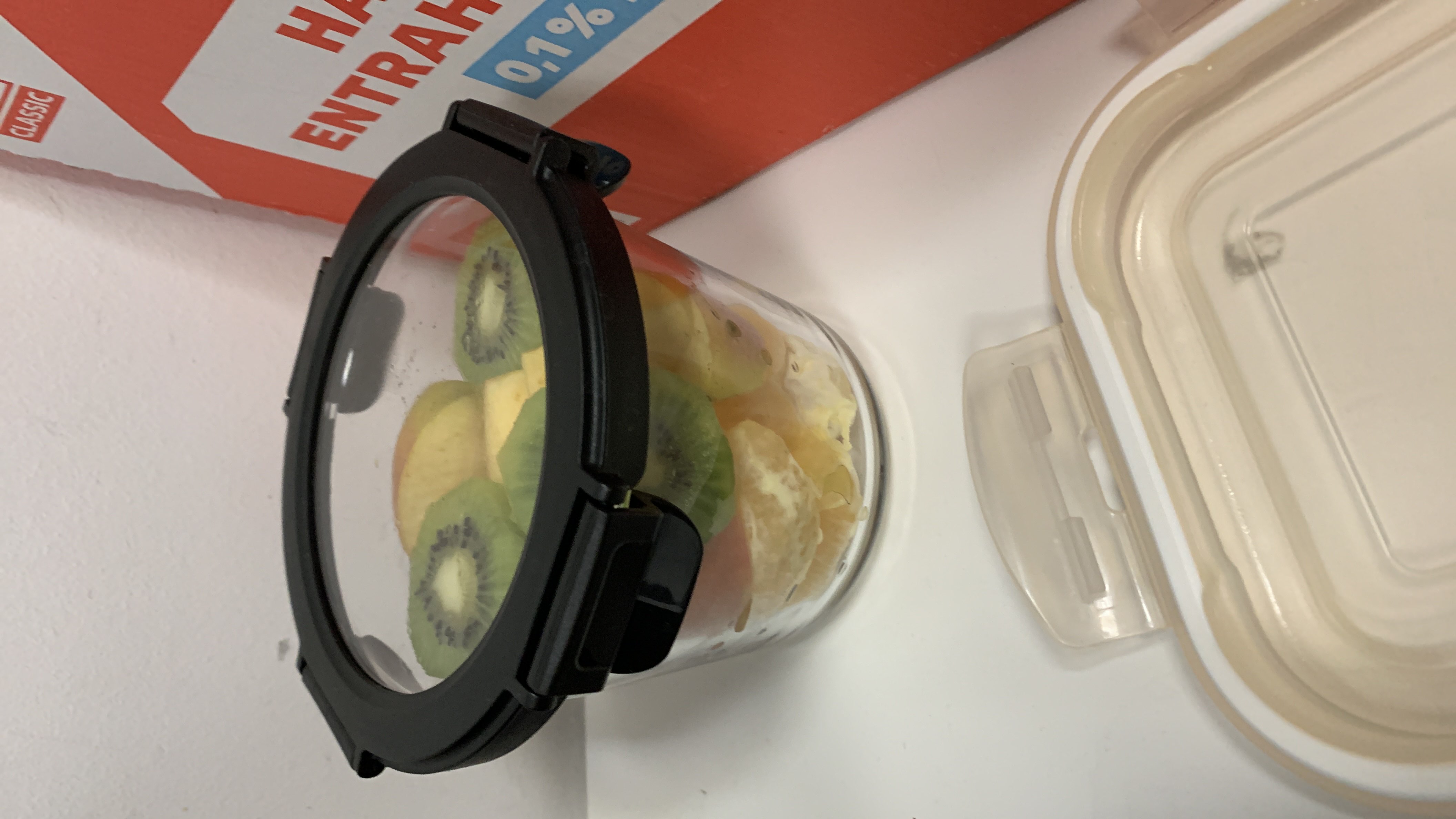 A fresh fruit salad containing kiwi, apple, and orange, providing a healthy and low-calorie snack option.