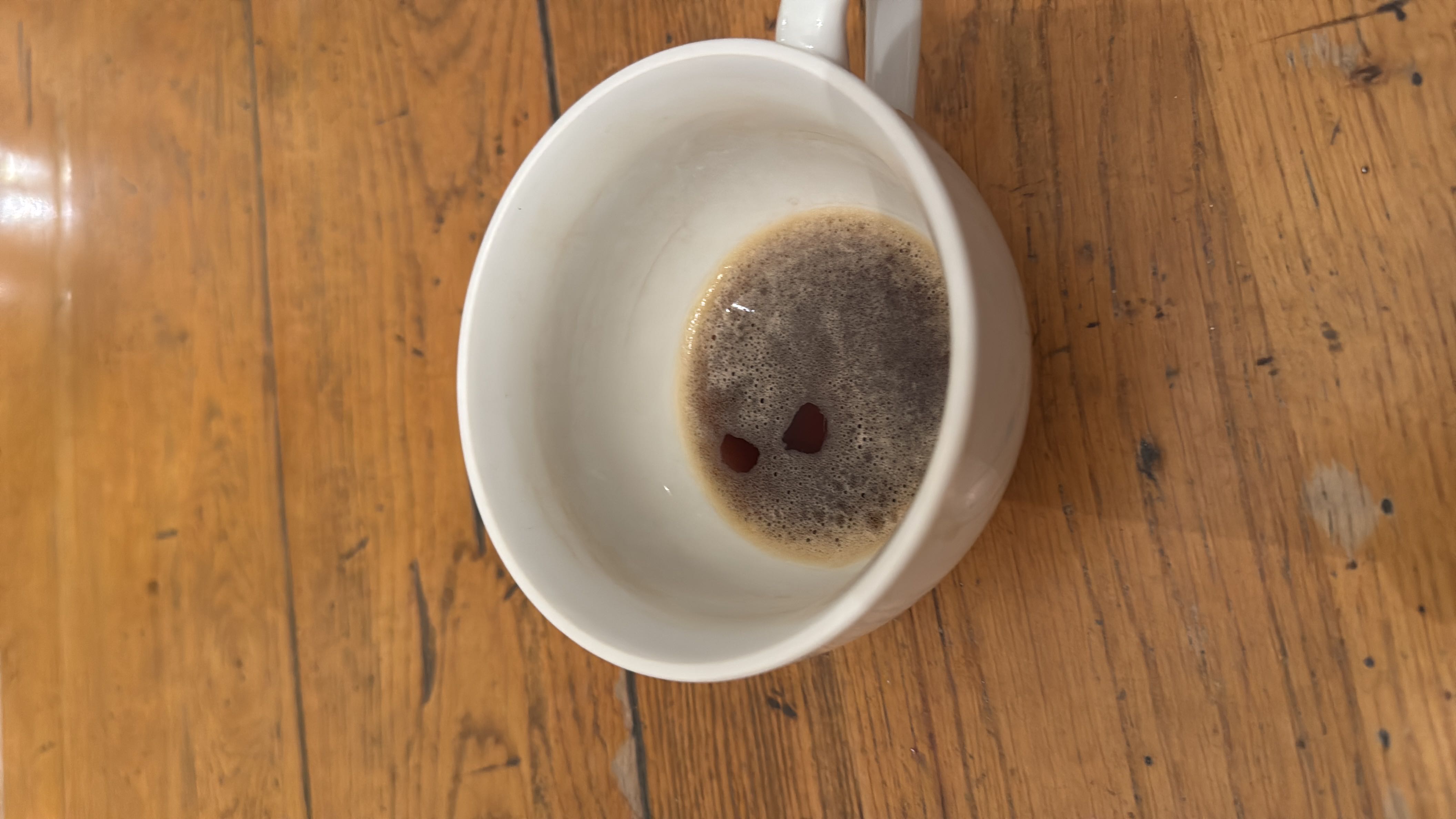 A cup of black coffee with minimal calories and no significant macronutrients.