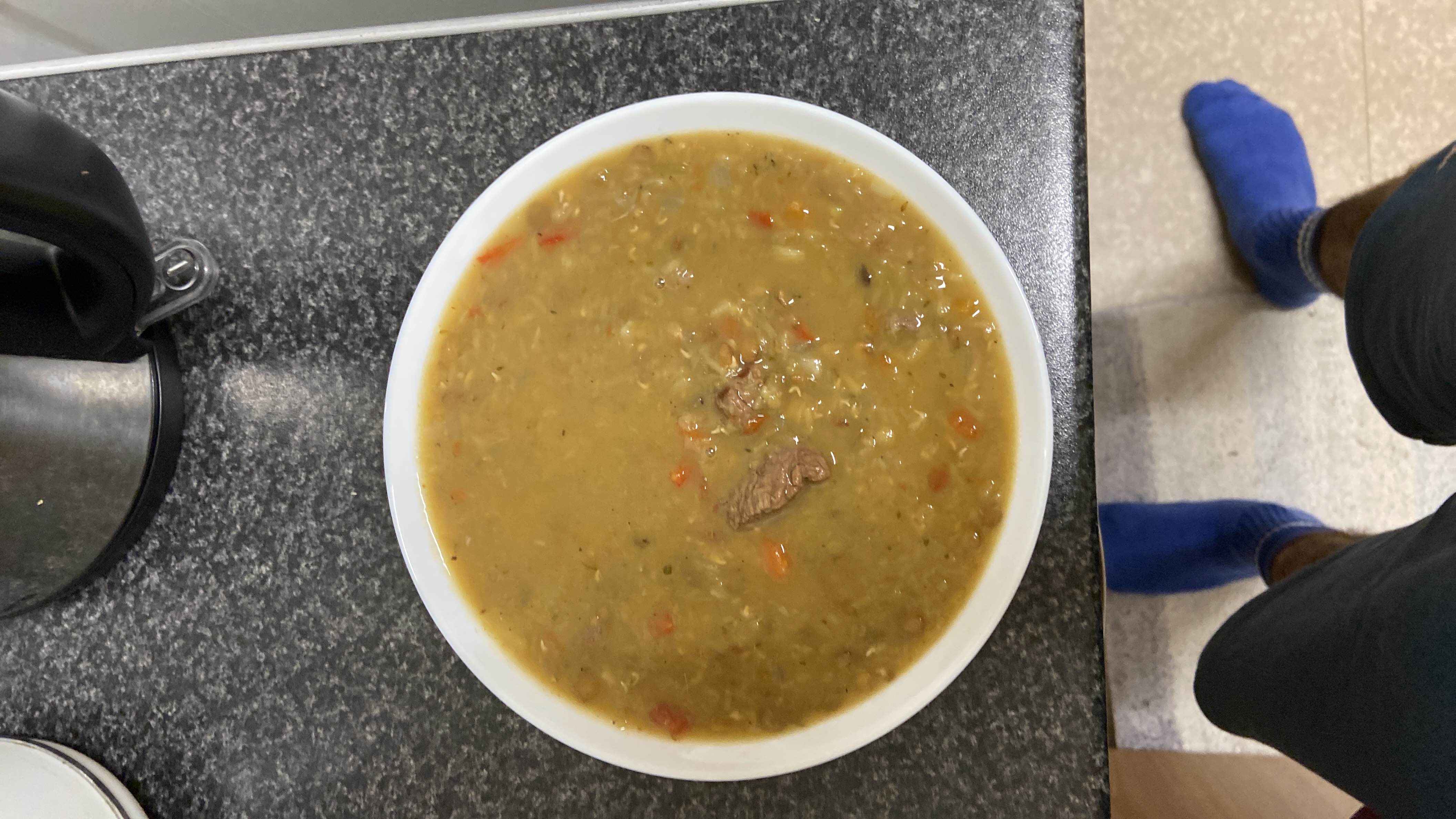 A hearty lentil and beef soup with vegetables, providing a balanced mix of protein, carbs, and fats.