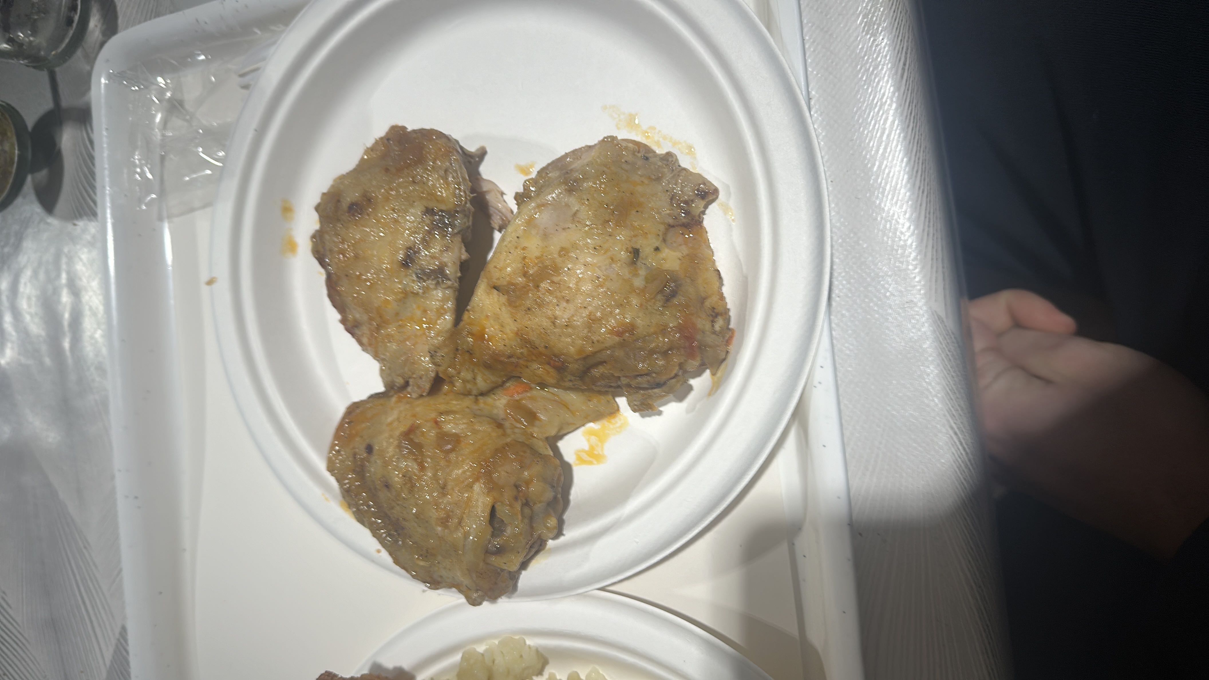 The image shows three cooked chicken thighs, which are high in protein and fats with minimal carbohydrates.