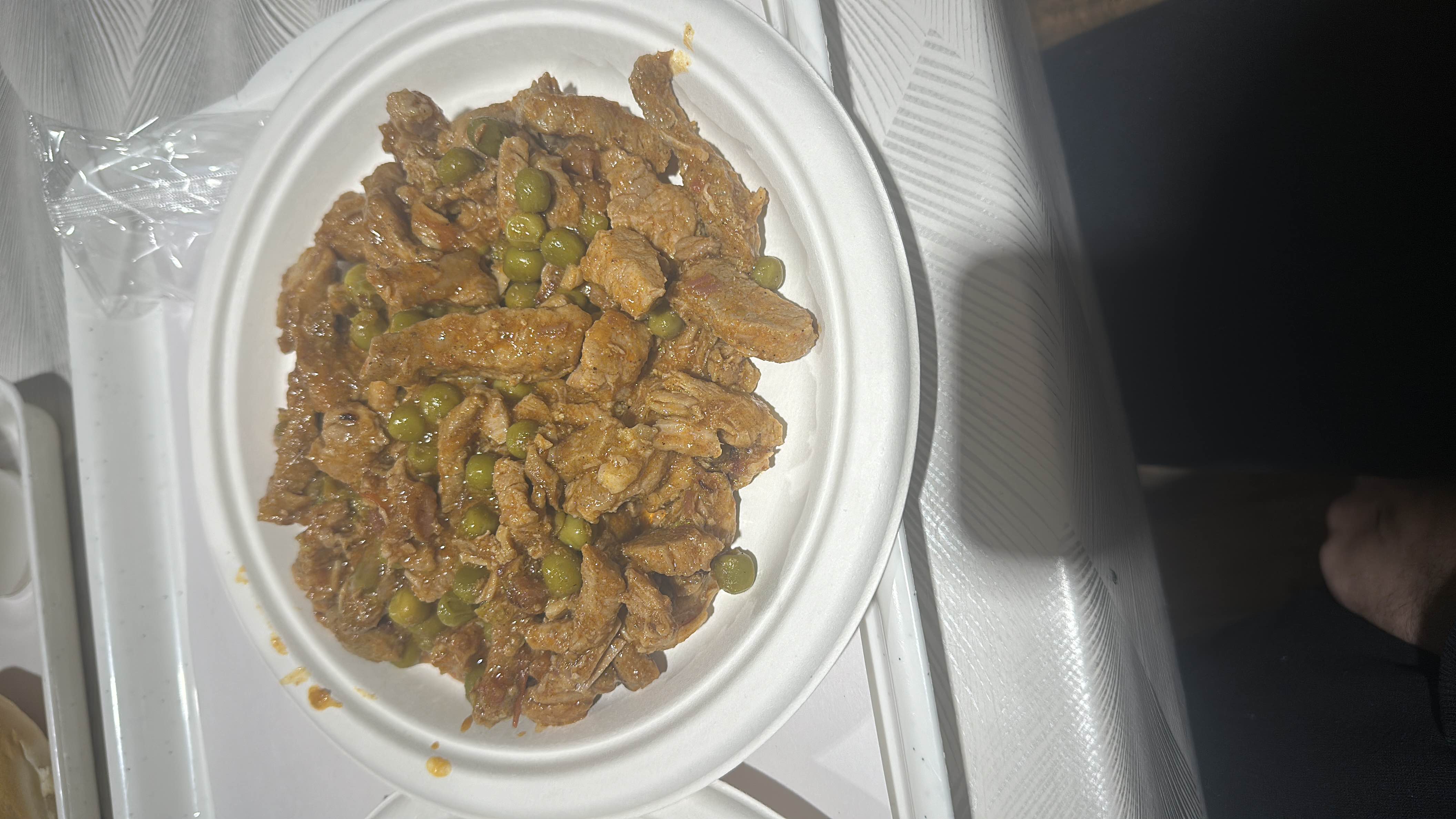 A dish consisting of beef strips cooked with green peas in a savory sauce, providing a balanced mix of protein, carbs, and fats.