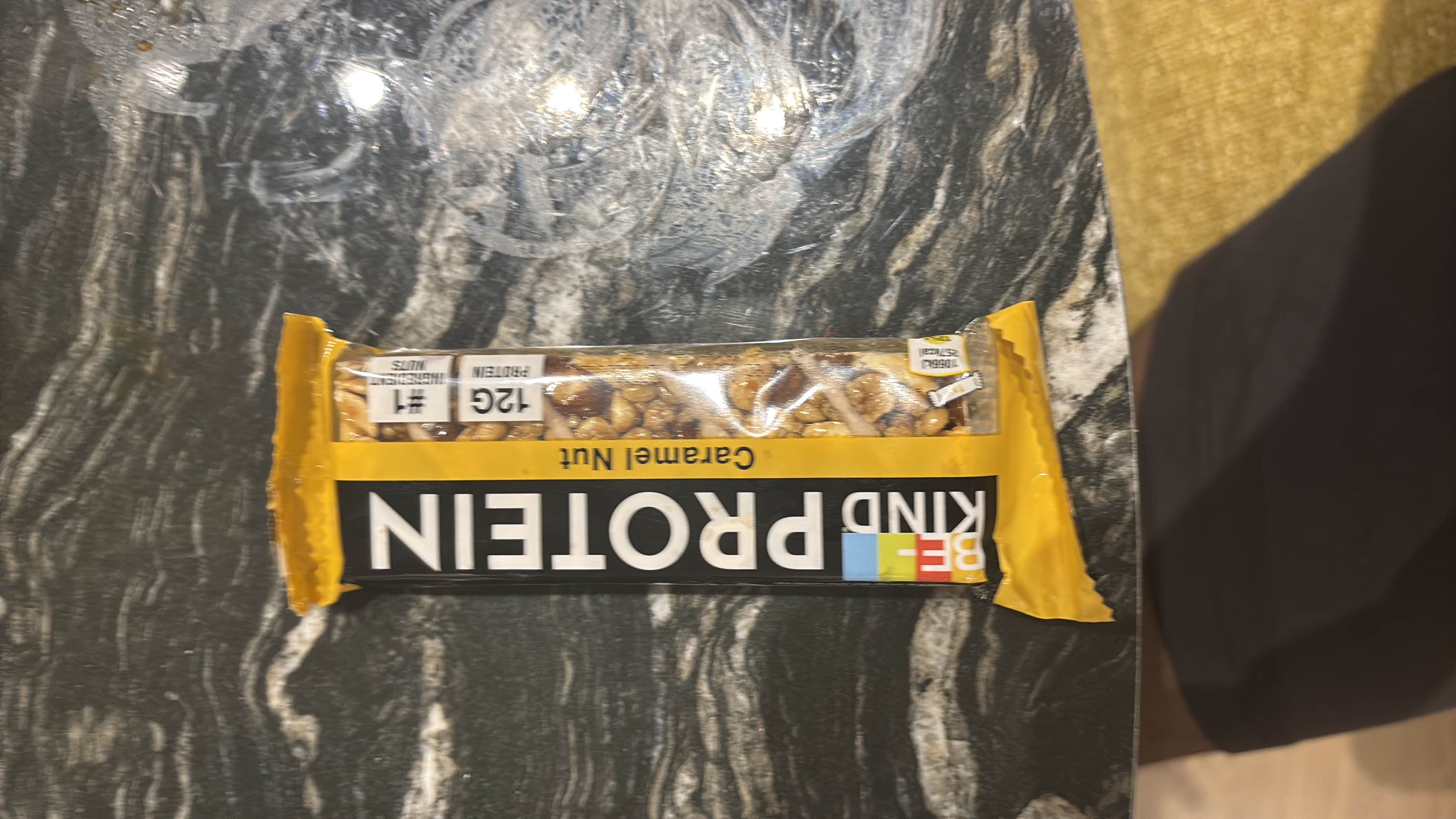A protein bar with caramel and nut ingredients, providing 12g of protein and 250 calories per serving.