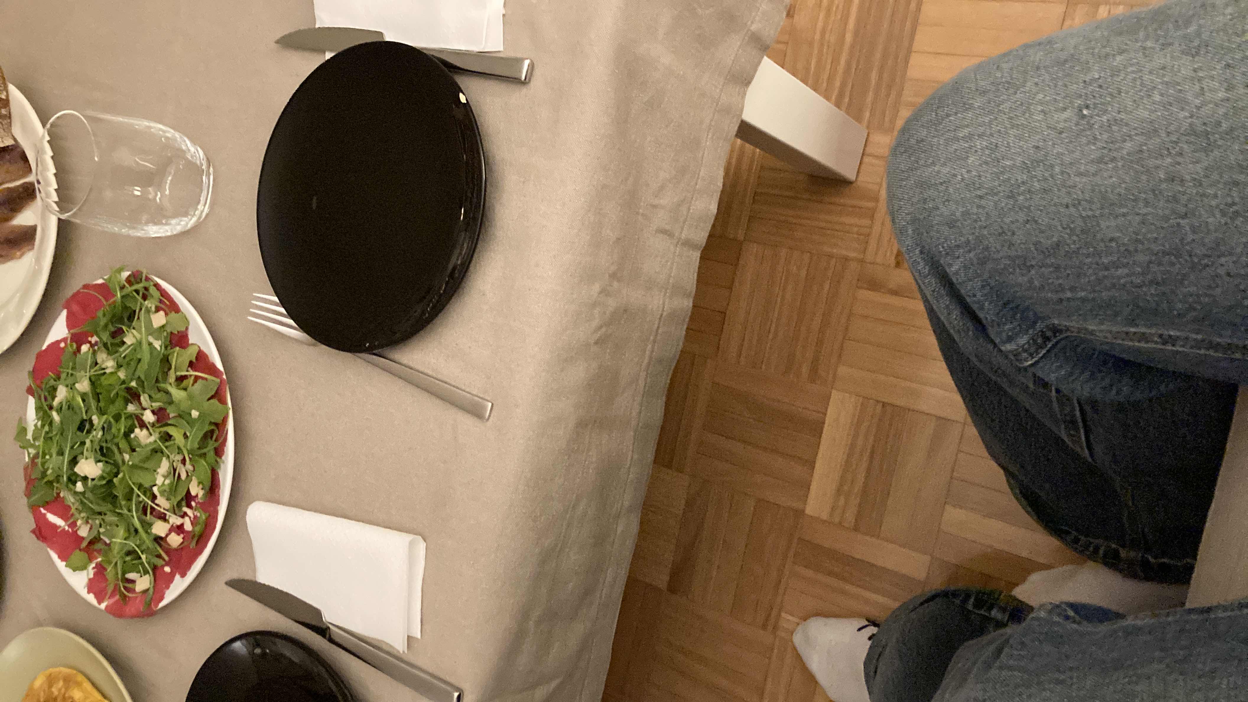 A light salad with arugula, beetroot, and parmesan, served as part of a meal.