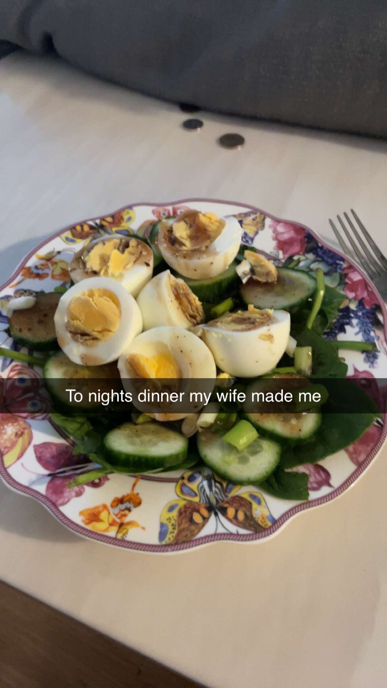 A healthy salad consisting of boiled eggs, cucumber, spinach, mushrooms, and a light dressing.
