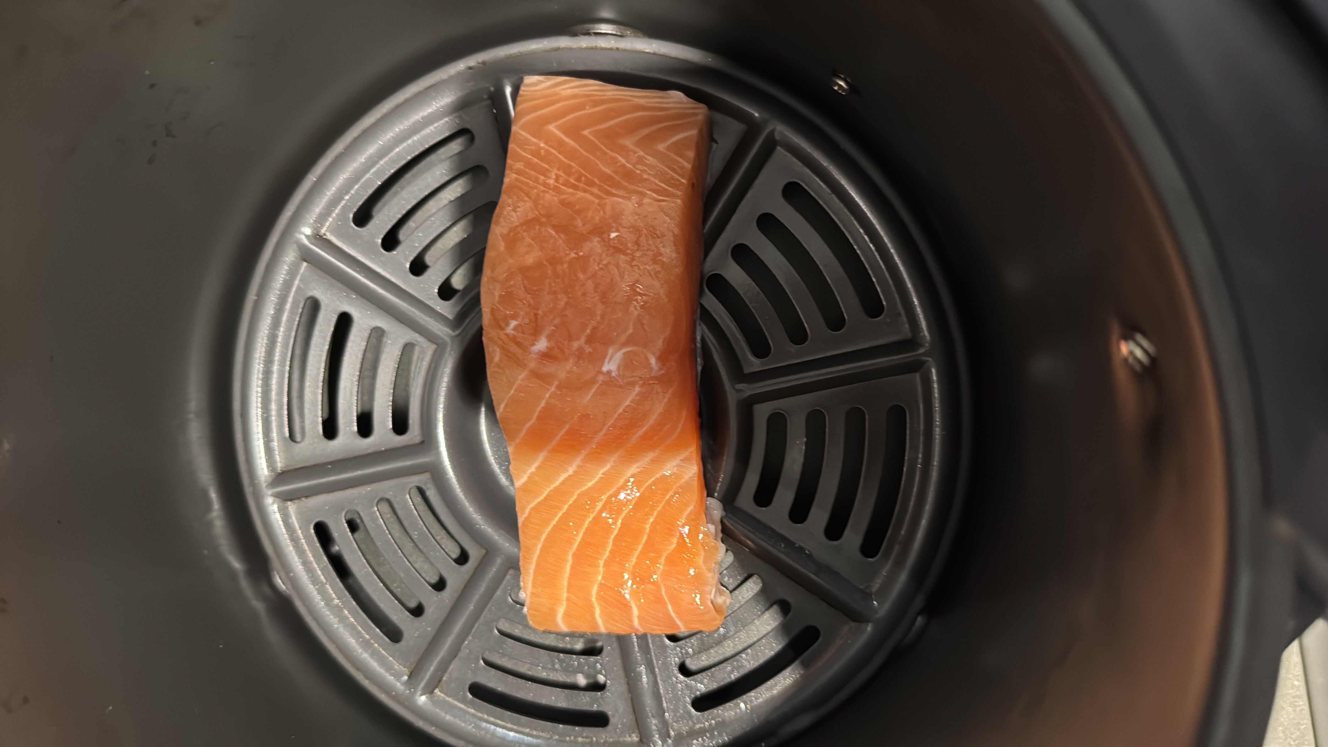 The image shows a raw salmon fillet, which is a high-protein, low-carb food rich in healthy fats.