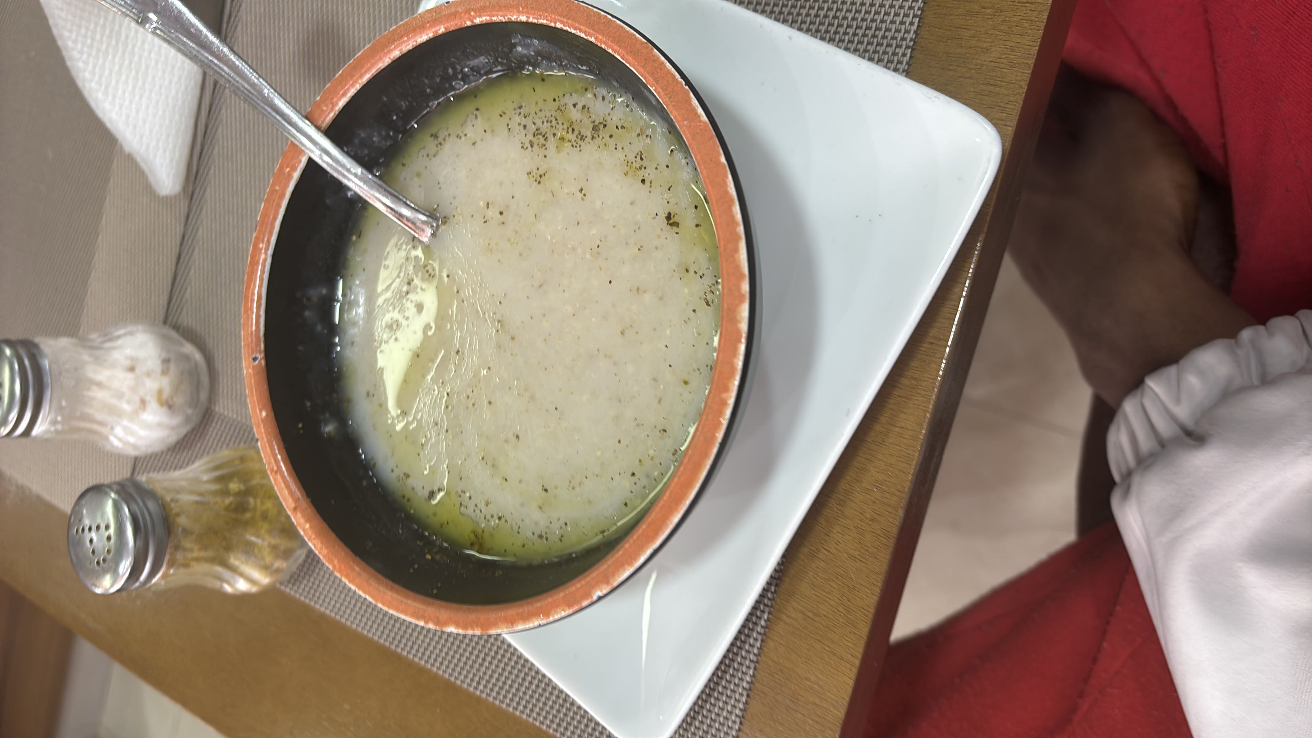 A bowl of wheat porridge with butter, seasoned with spices, served as a light and nutritious meal.