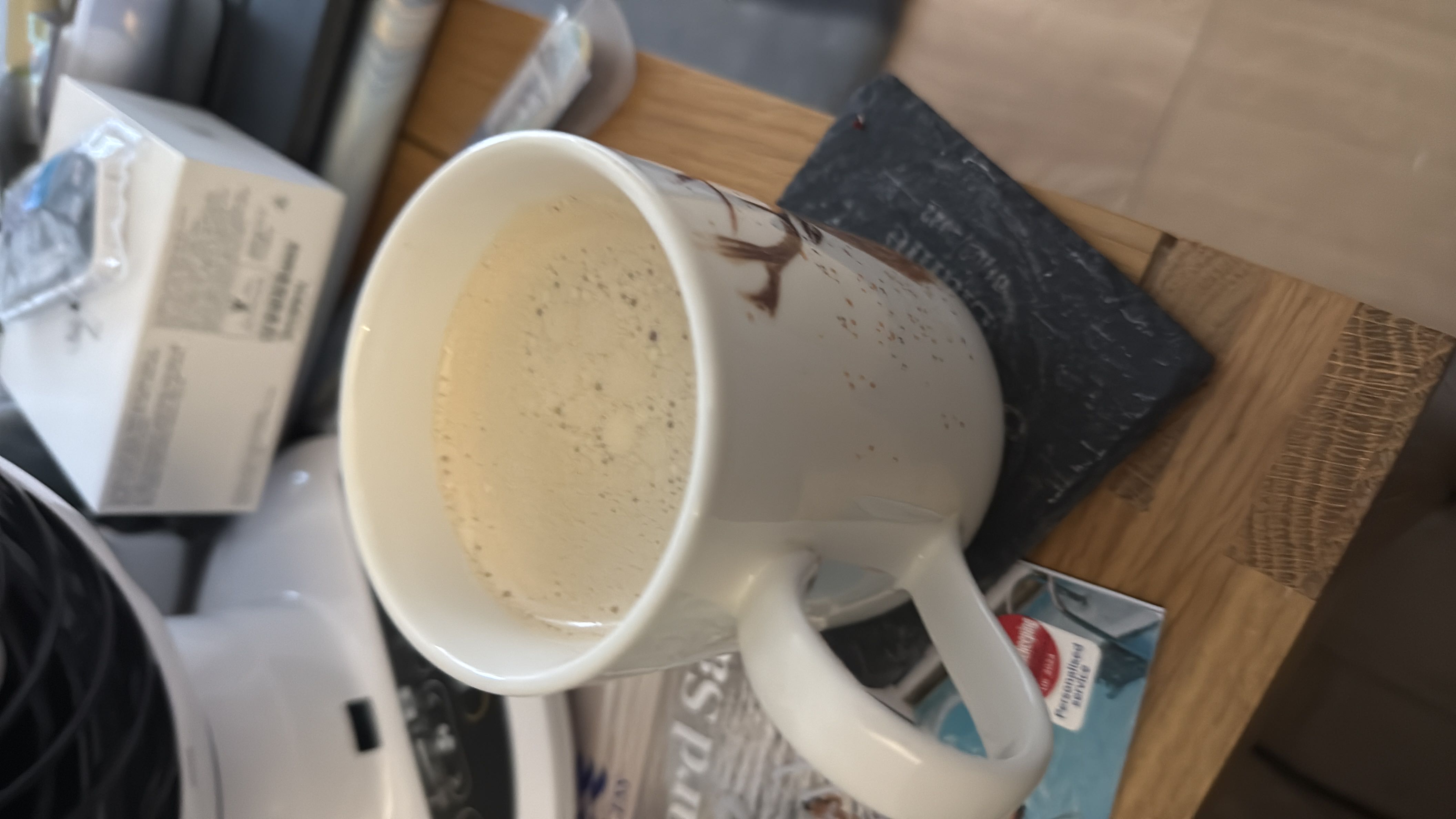 A cup of coffee with milk, providing a moderate amount of calories and nutrients.