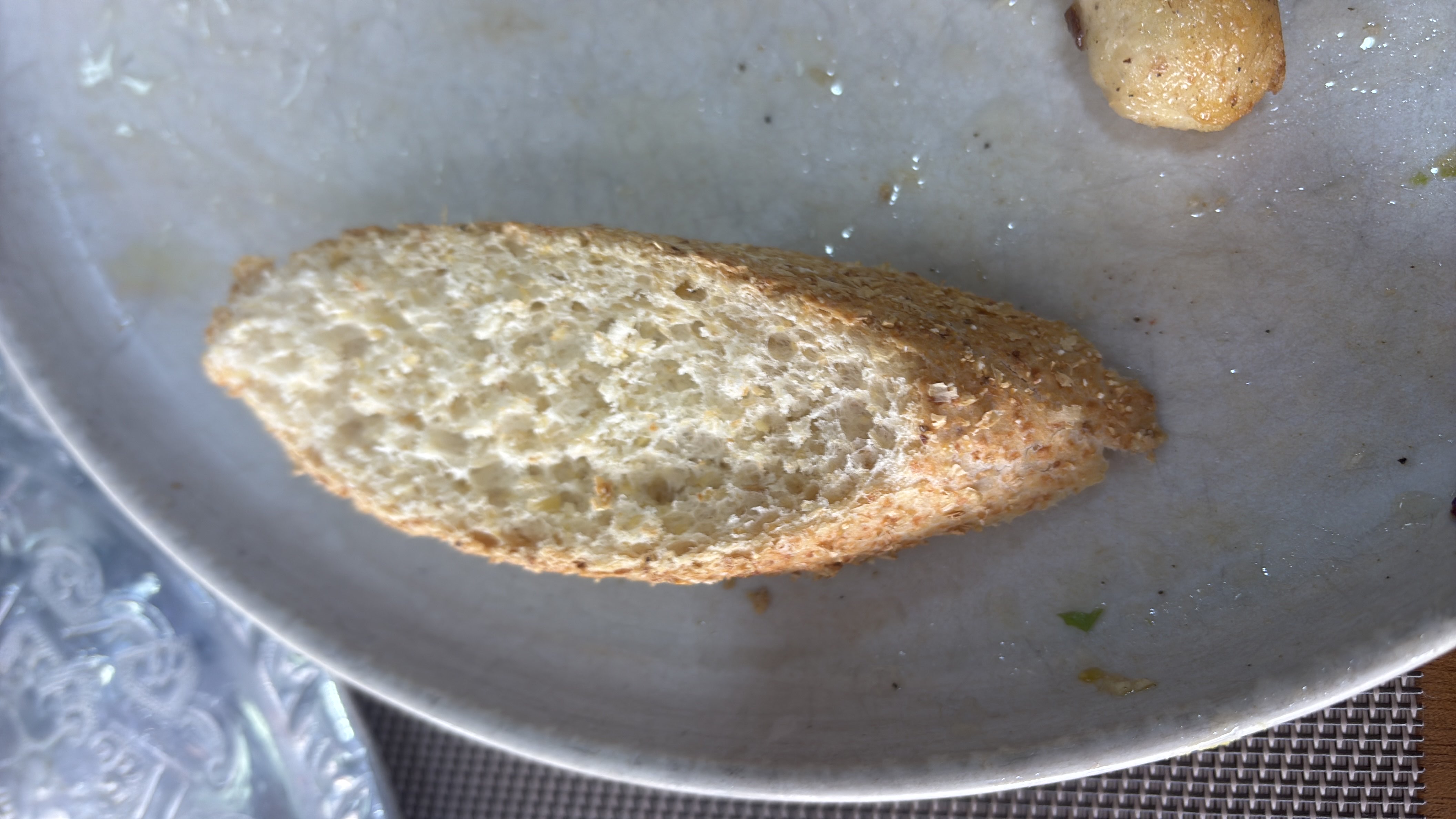 A slice of whole-grain bread, likely a source of carbohydrates with minimal fats and protein.