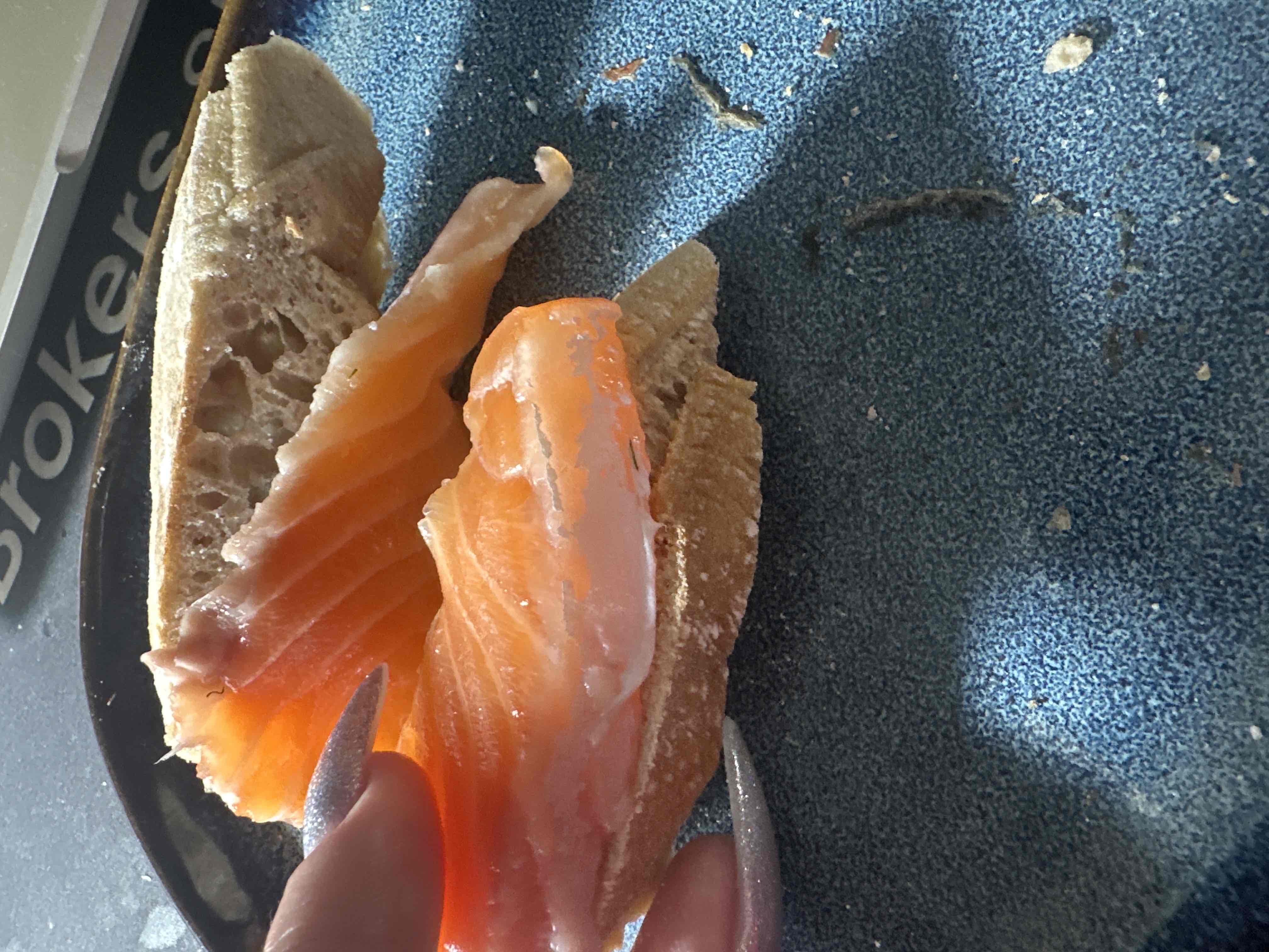 A dish consisting of fresh salmon slices served on bread, providing a balanced mix of protein, carbs, and fats.