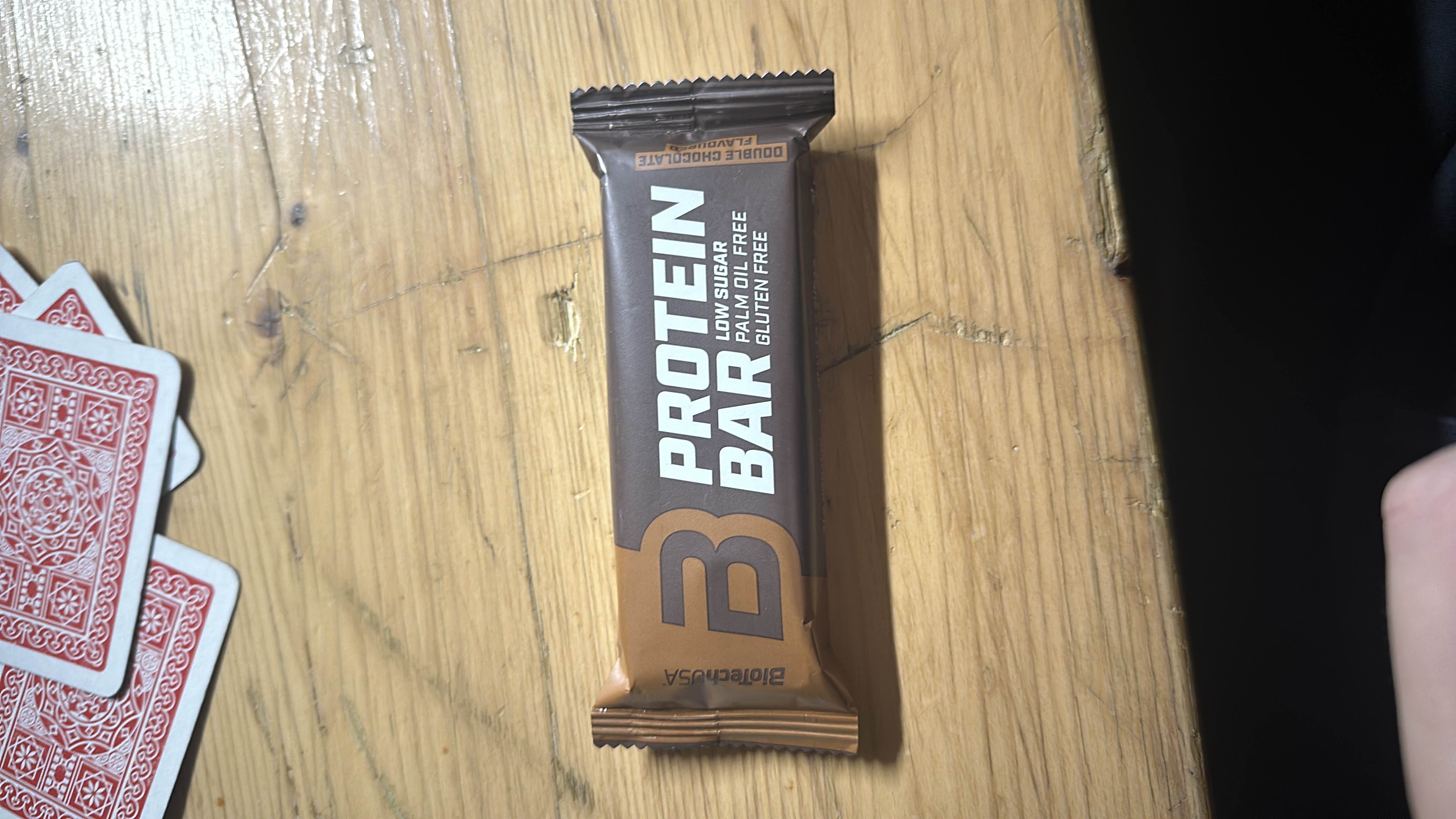 A low-sugar, palm oil-free, gluten-free protein bar with a double chocolate flavor, providing a balanced mix of protein, carbs, and fats.