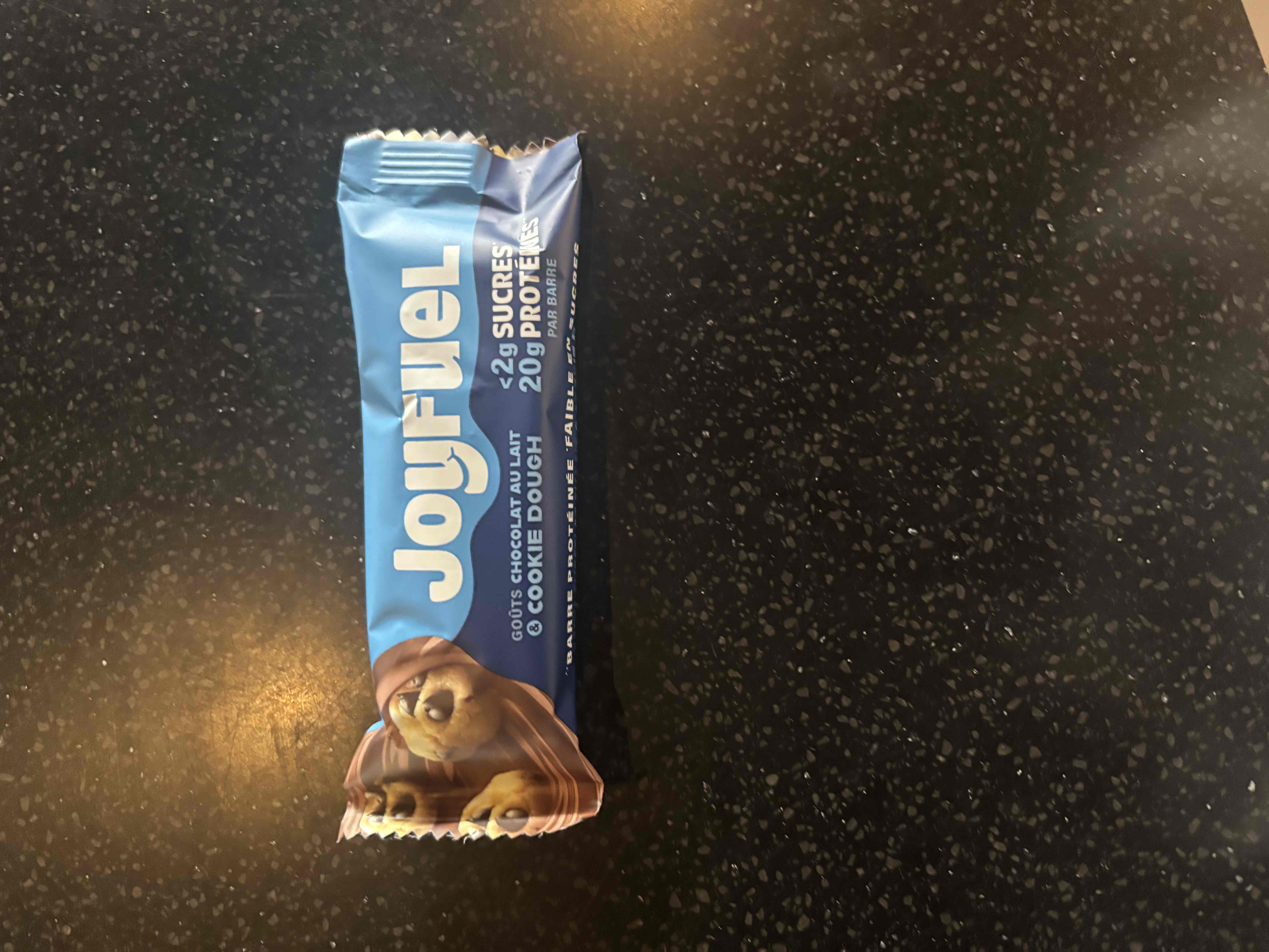 A protein bar with a cookie dough flavor, containing 20g of protein, less than 2g of sugar, and a balanced nutritional profile.