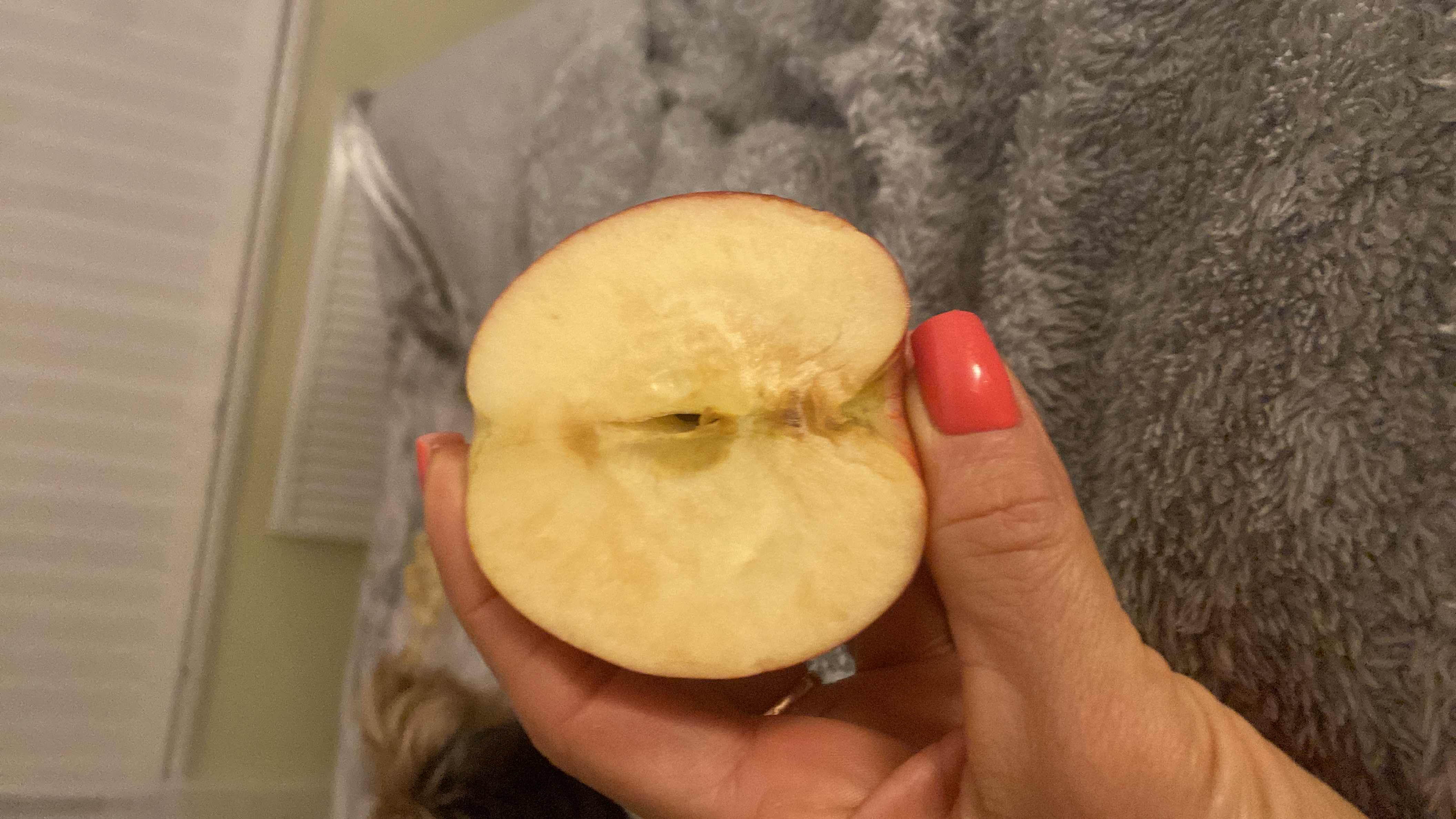 The image shows a halved apple, which is a low-calorie fruit rich in carbohydrates and has a high health score.