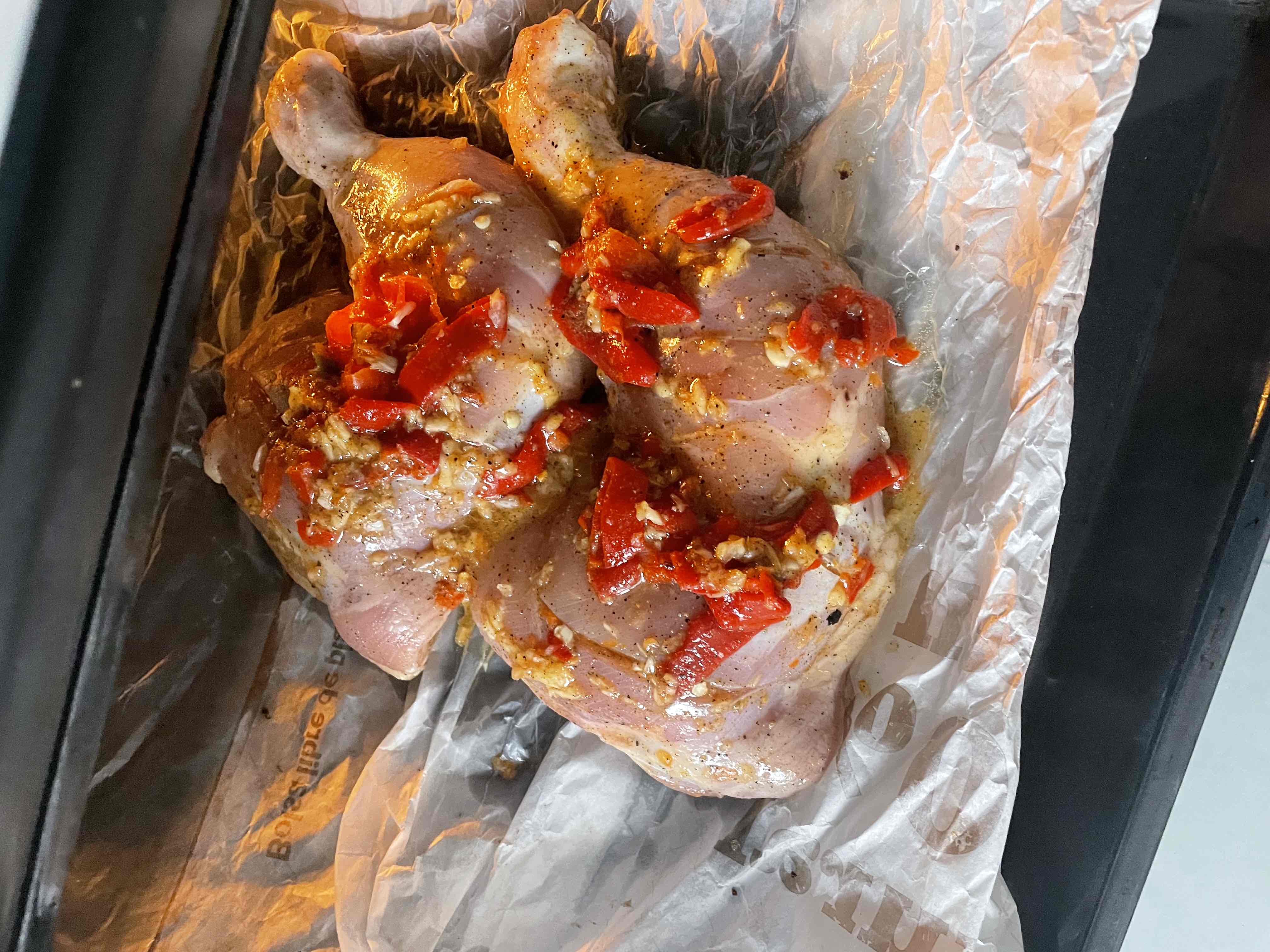 Oven-baked chicken legs seasoned with garlic, red pepper, and olive oil, providing a high-protein, moderate-fat meal.