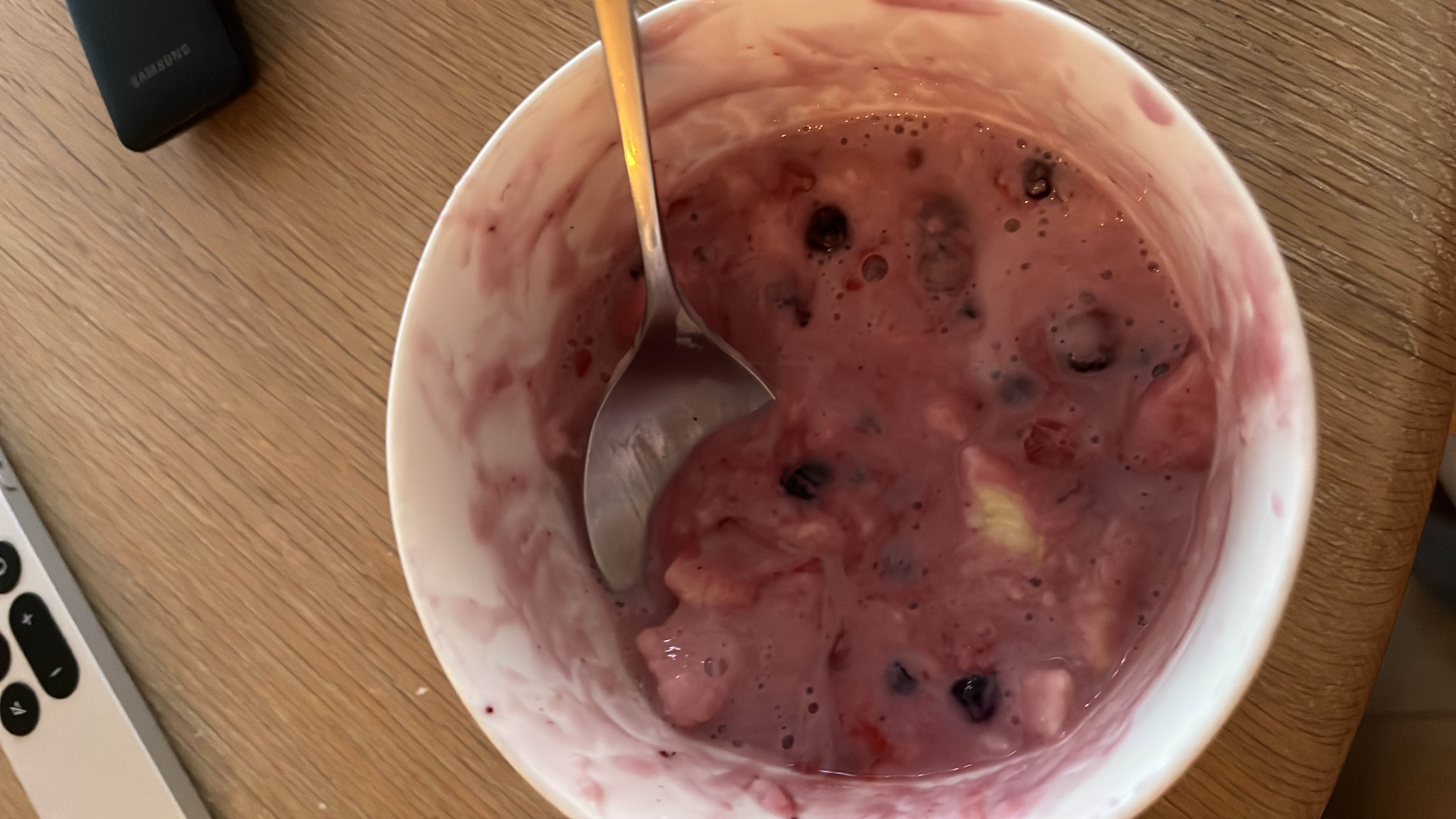 A bowl of yogurt mixed with berries and banana, providing a balanced mix of protein, carbs, and fats.