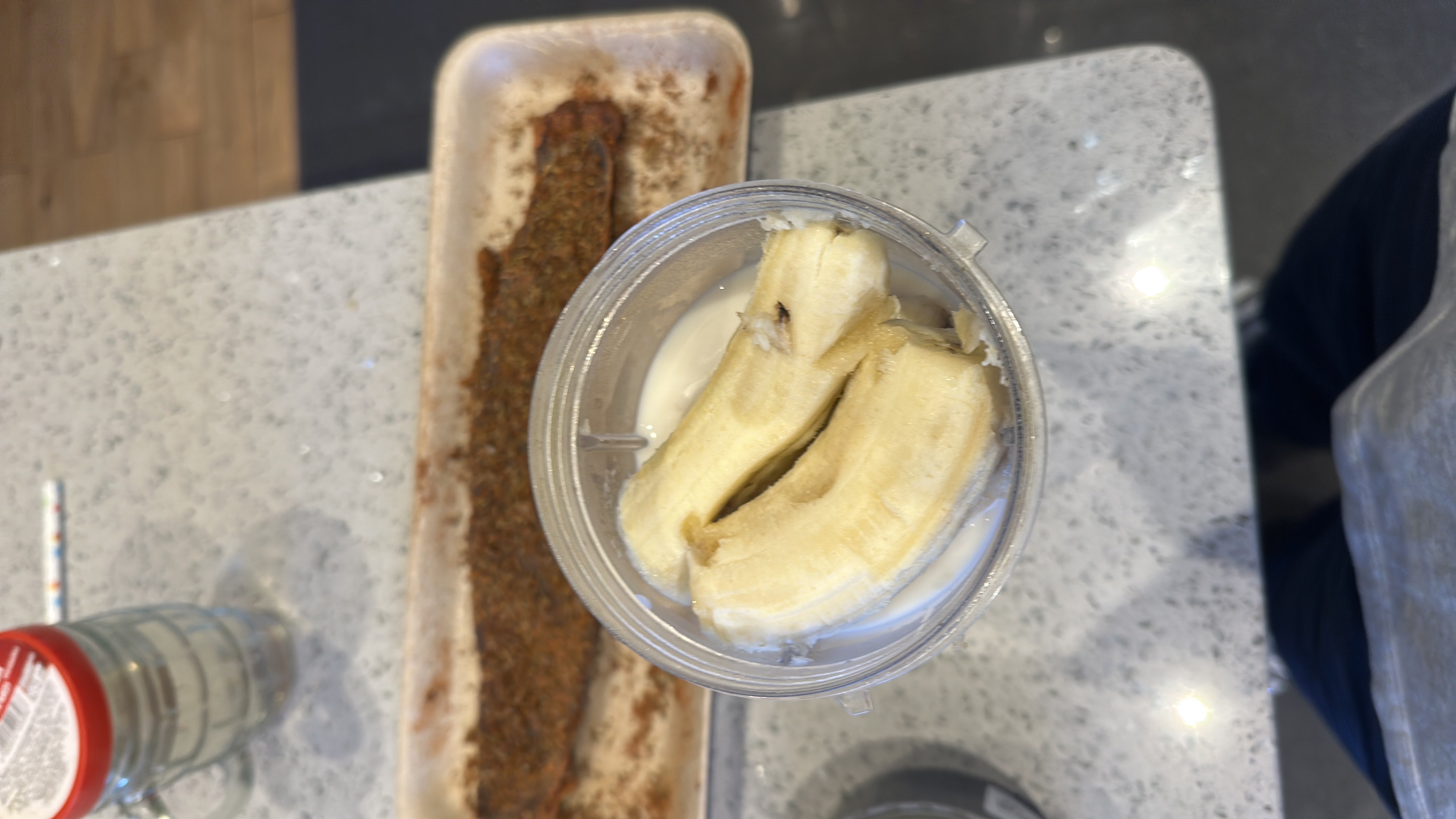 A smoothie preparation with banana, milk, and flaxseed, providing a balanced mix of carbs, protein, and fats.