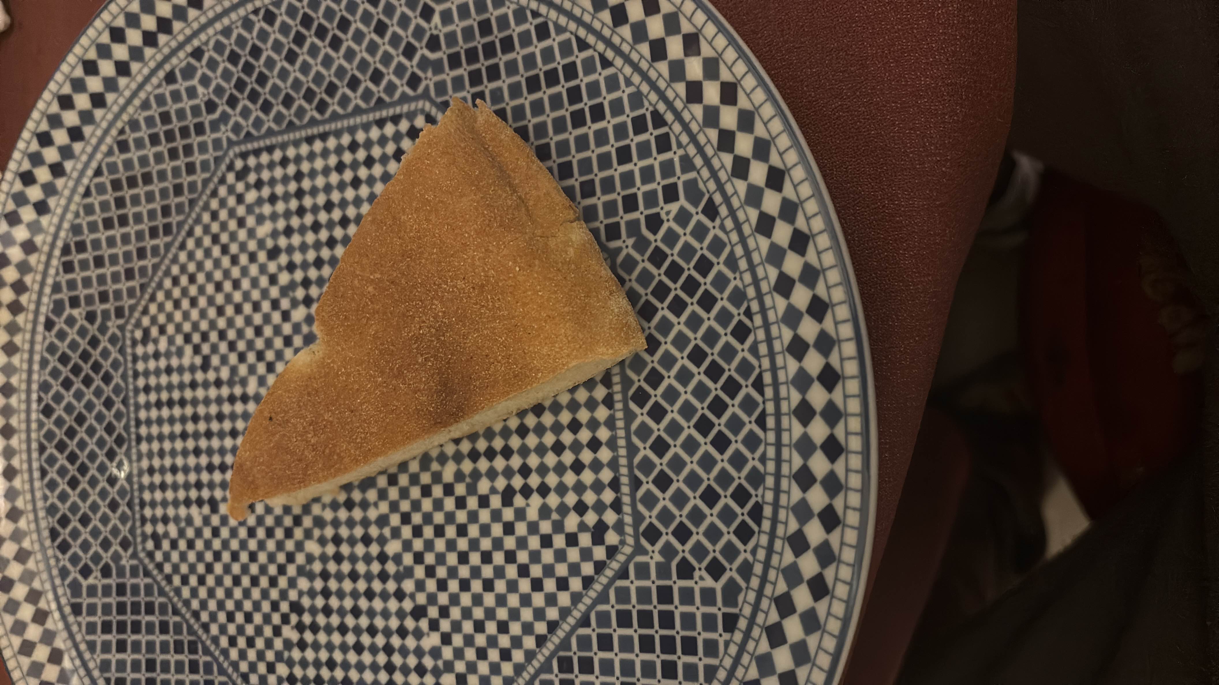 A single slice of bread on a decorative plate, providing moderate calories with a balance of carbs, protein, and fats.