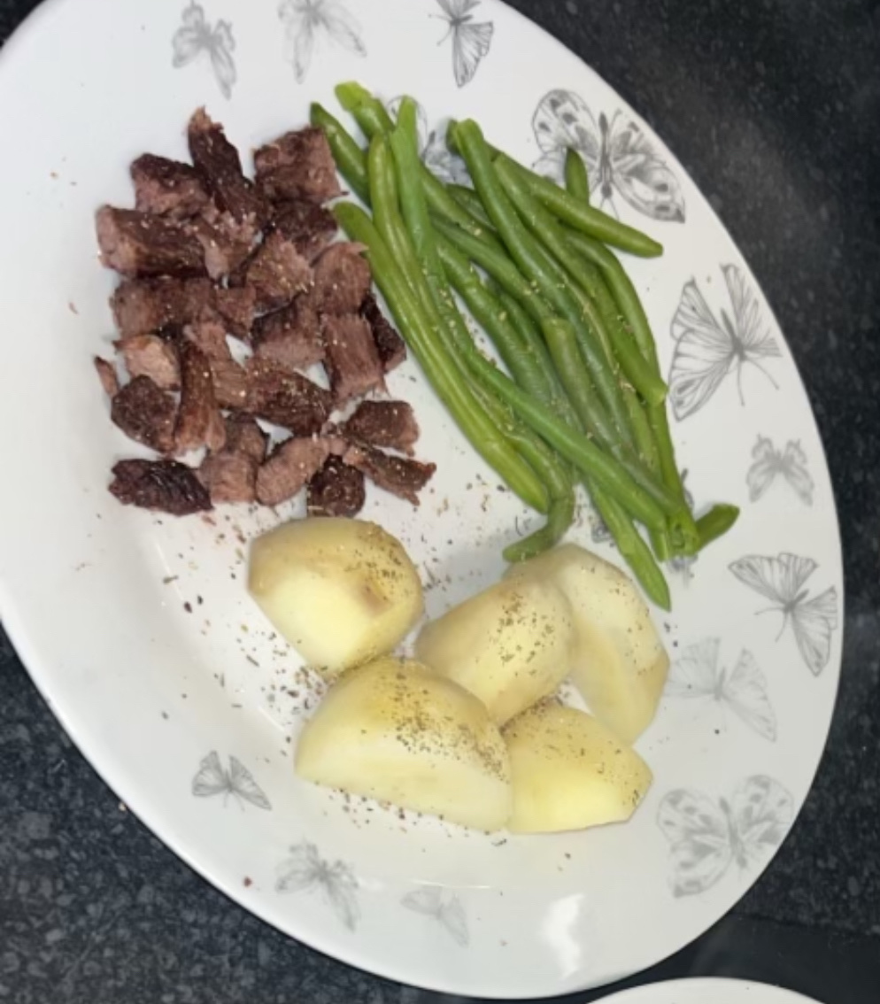 A balanced meal consisting of beef, green beans, and potatoes, providing a good mix of protein, carbs, and fats.