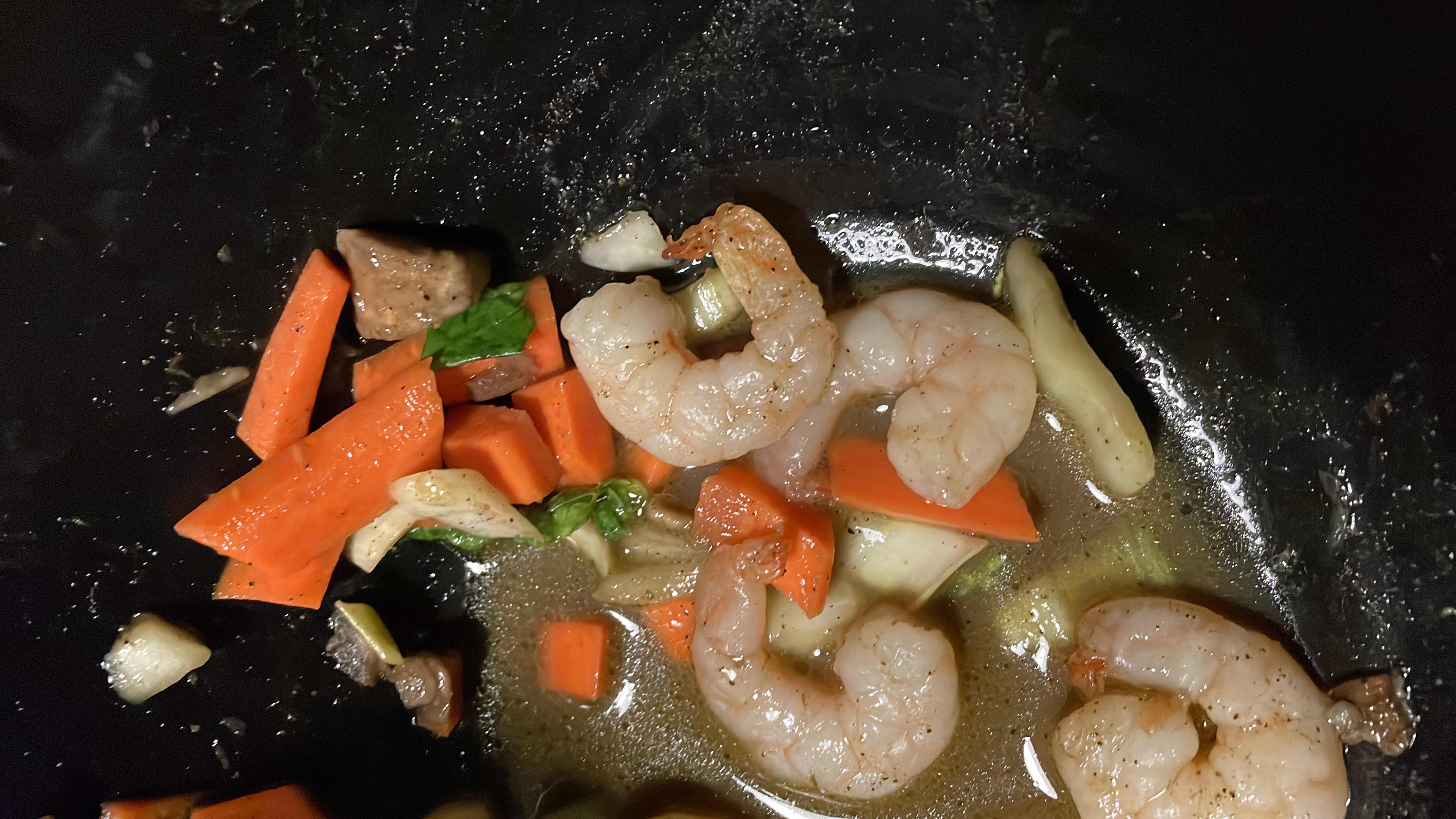 A light and healthy dish featuring shrimp, carrots, bok choy, and mushrooms in a flavorful broth.