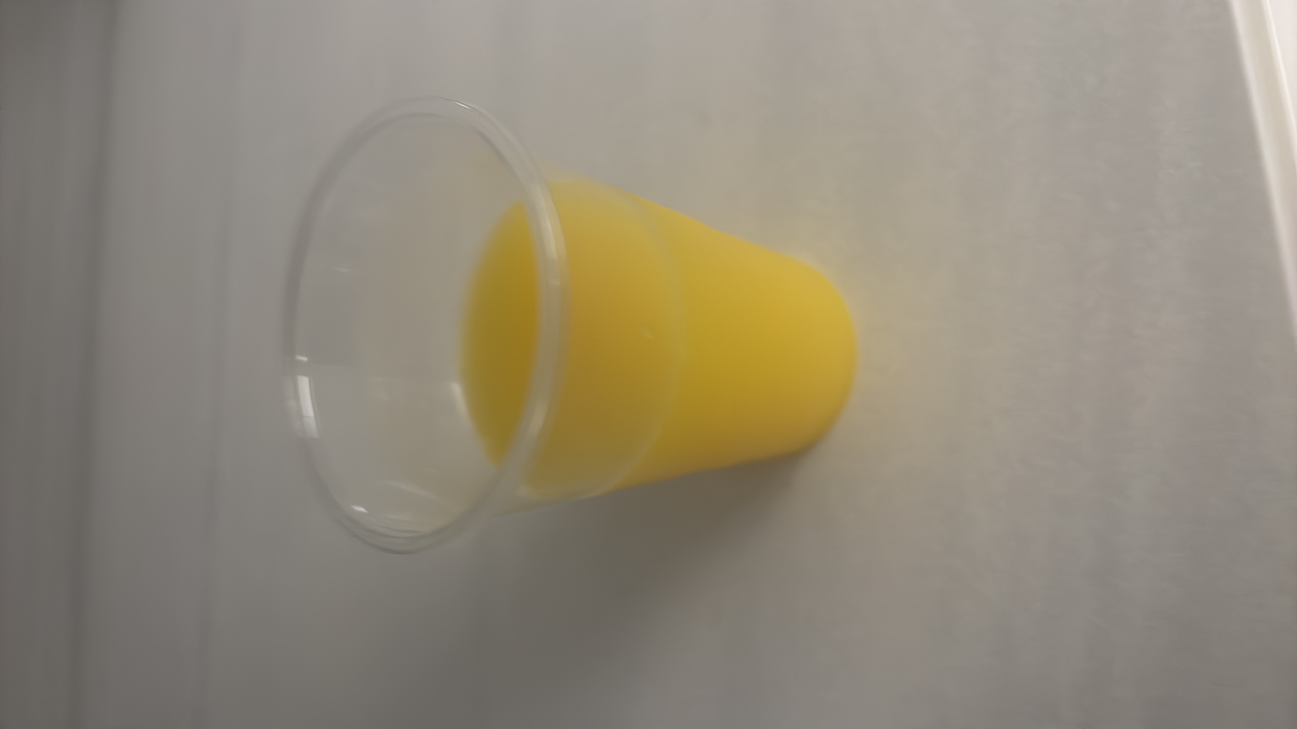 A small cup of orange juice, a low-calorie beverage rich in carbohydrates and vitamin C.