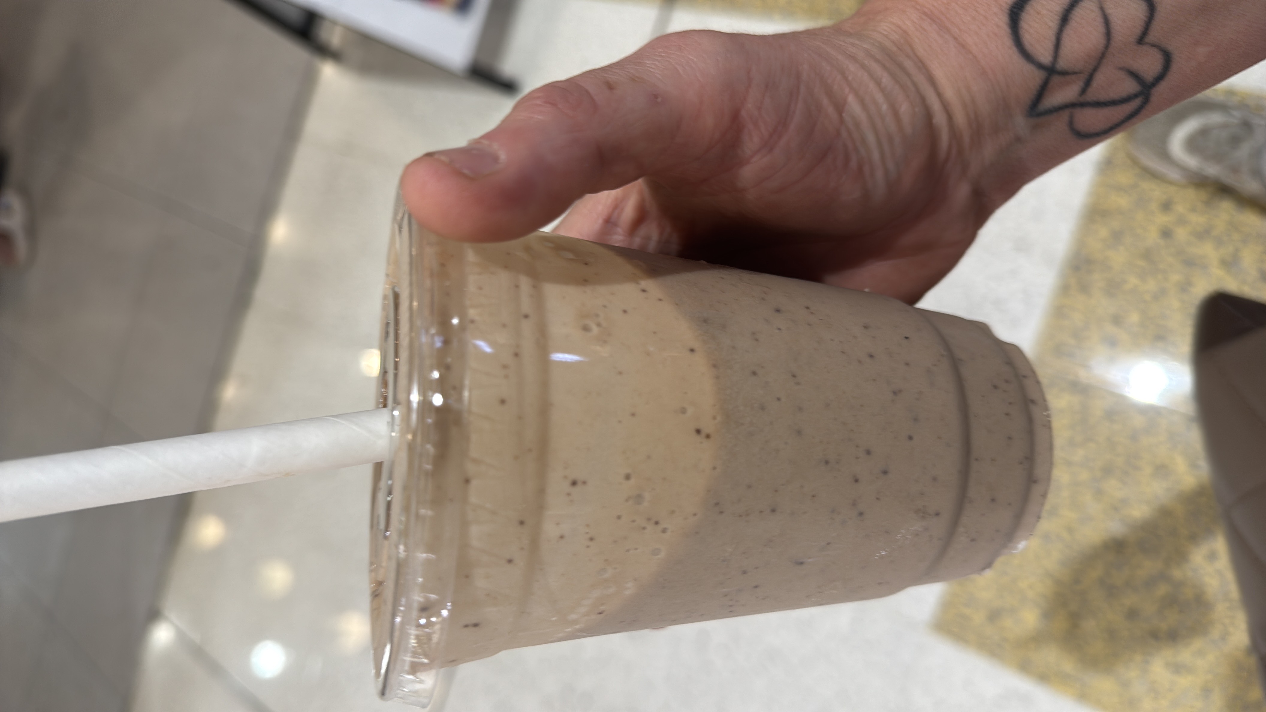 A creamy protein shake made with banana, peanut butter, almond milk, and protein powder, providing a balanced mix of macronutrients.
