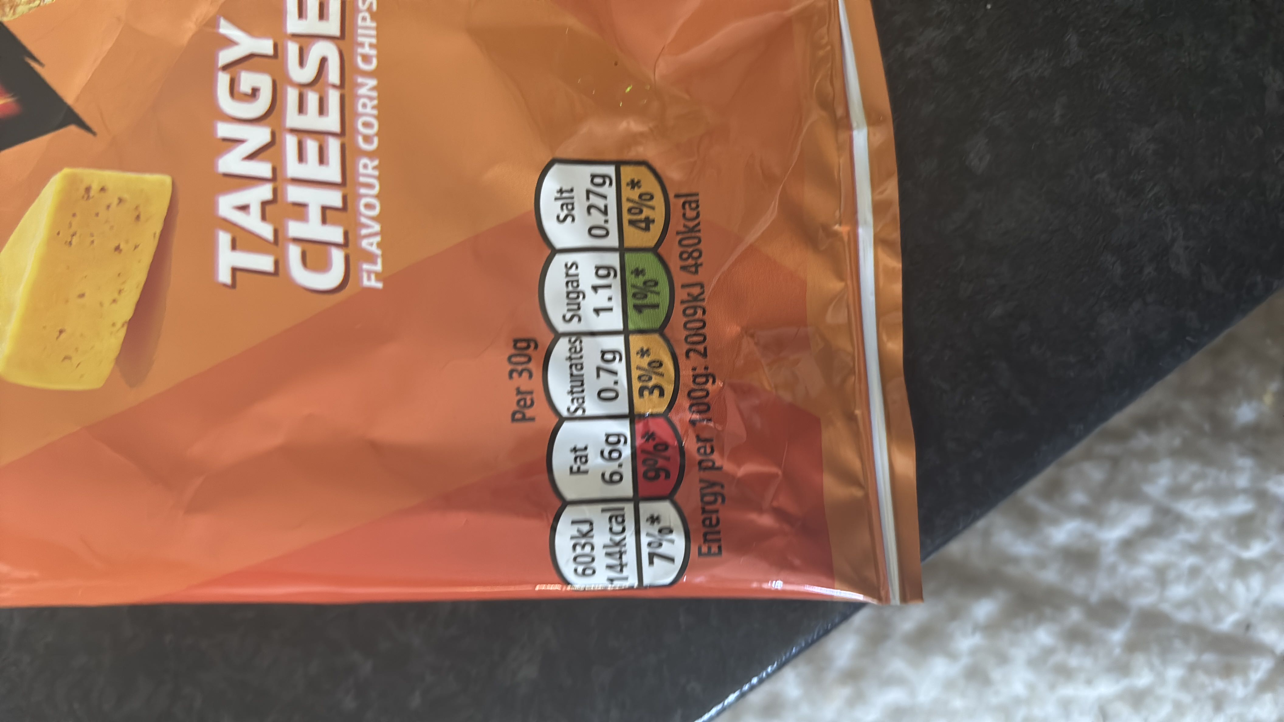 Tangy cheese-flavored corn chips with 144 calories per 30g serving, containing 6.6g of fat, 0.7g of saturated fat, 1.1g of sugar, and 0.27g of salt.