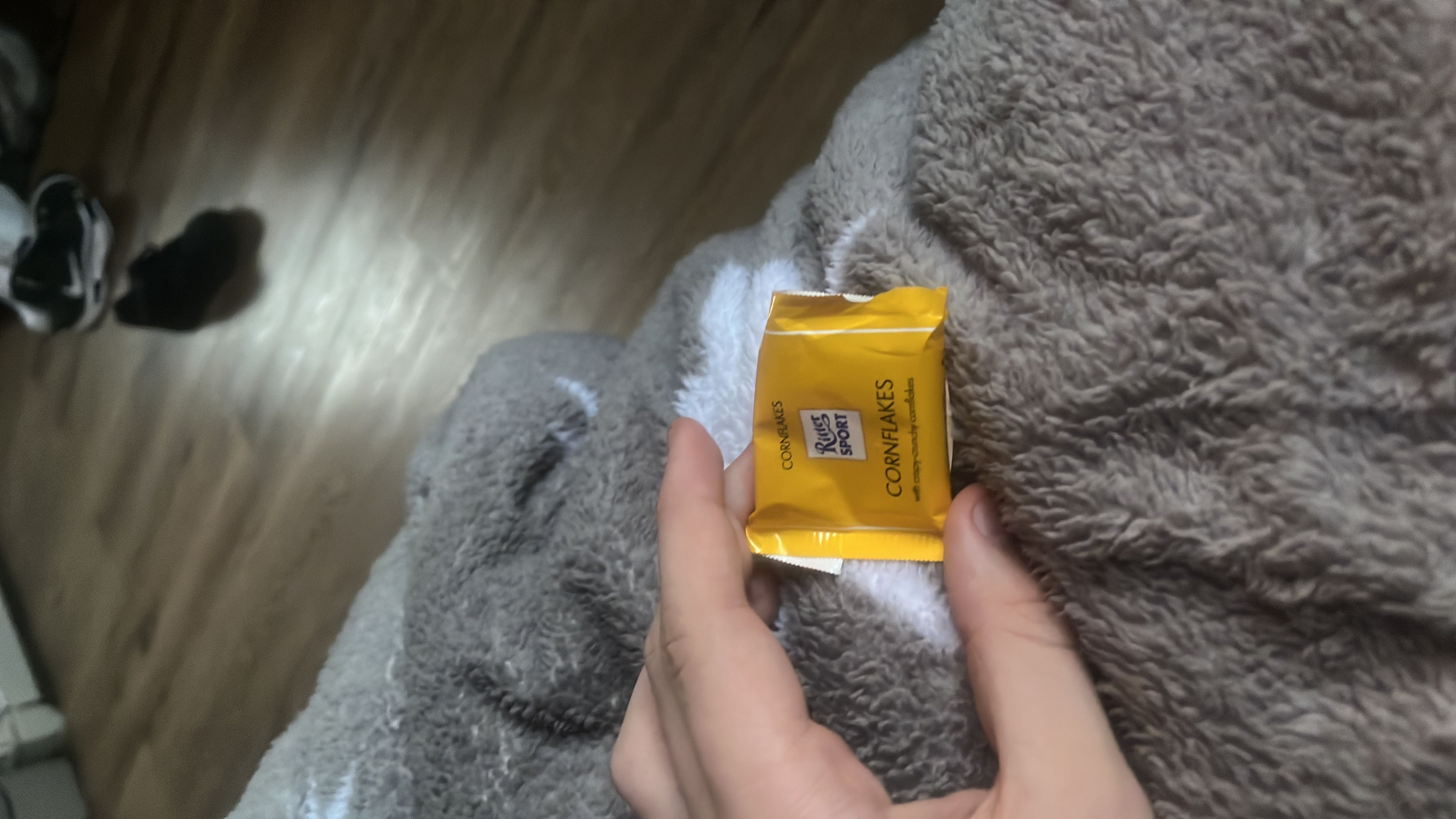 A small portion of Ritter Sport Cornflakes chocolate, combining milk chocolate with crispy cornflakes.