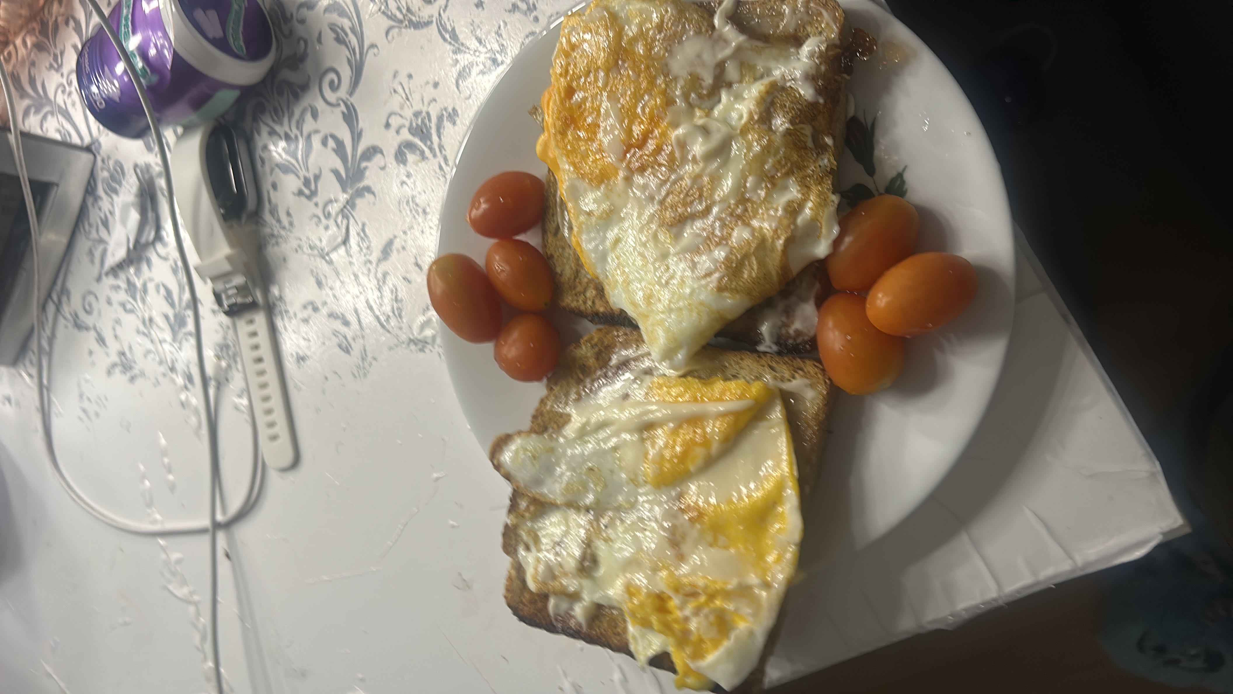 A plate of fried eggs on toast with cherry tomatoes, providing a balanced mix of protein, carbs, and fats.