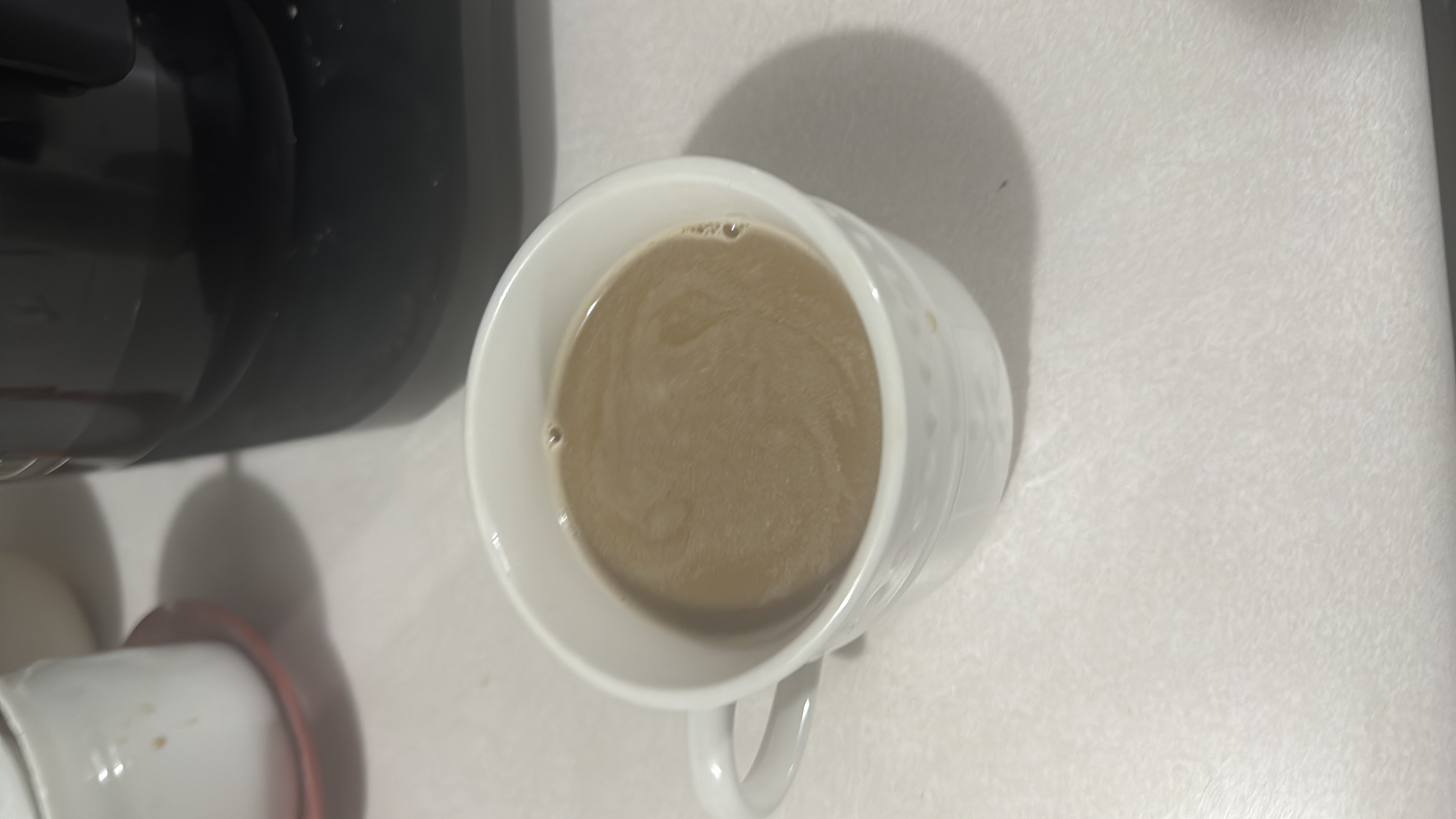 A cup of coffee with milk and sugar, providing a moderate calorie count and a balanced nutritional profile.