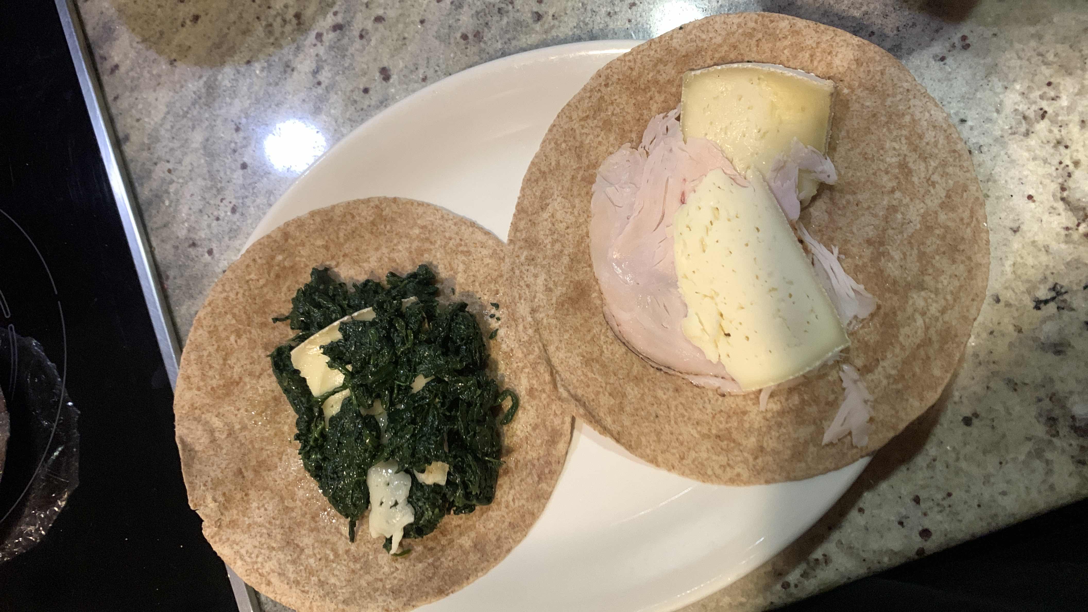 A healthy wrap made with whole wheat tortillas, spinach, cheese, and turkey slices, providing a balanced mix of protein, carbs, and fats.
