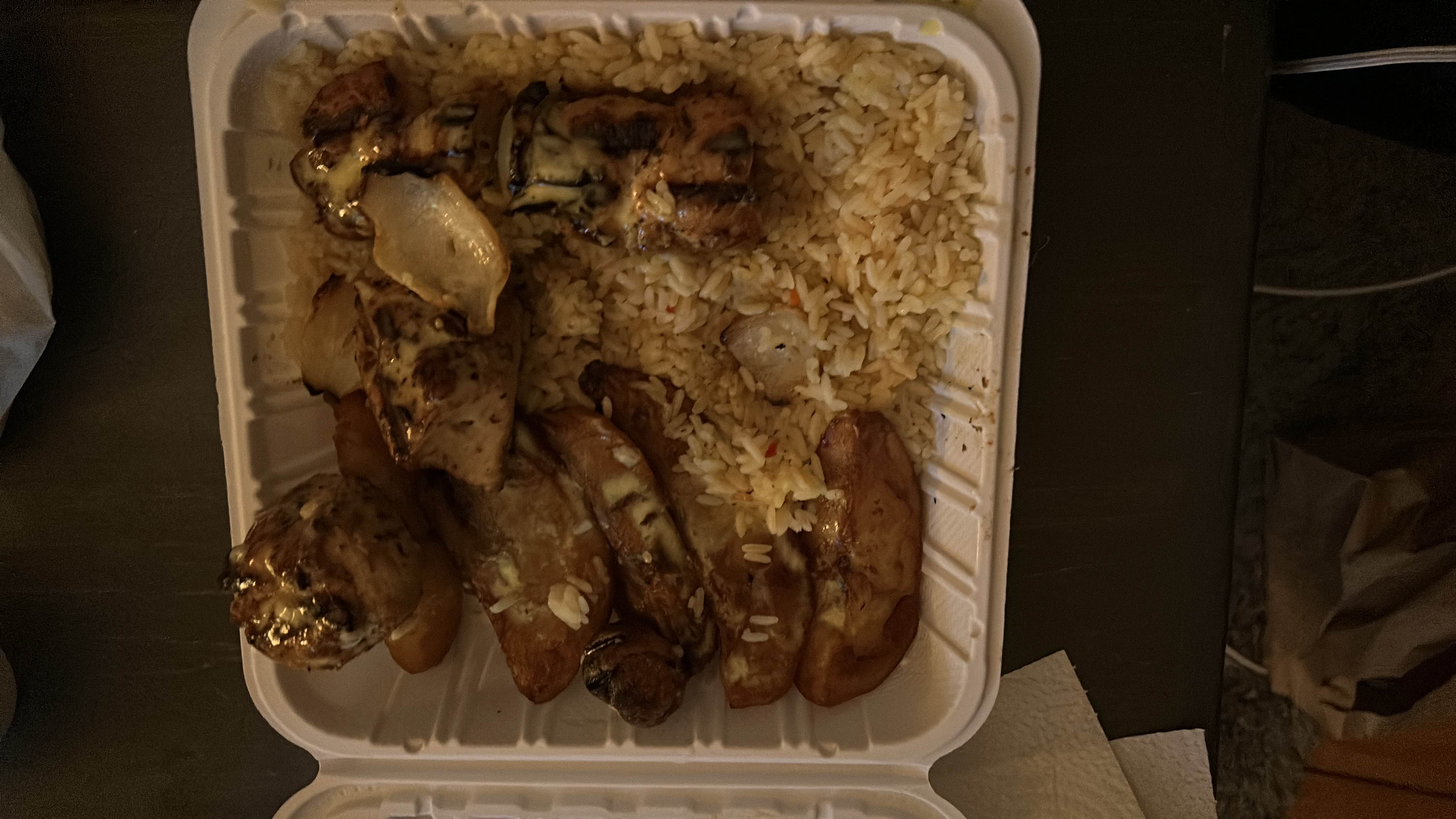 A meal consisting of grilled chicken, rice, and potato wedges, providing a balanced mix of protein, carbs, and fats.