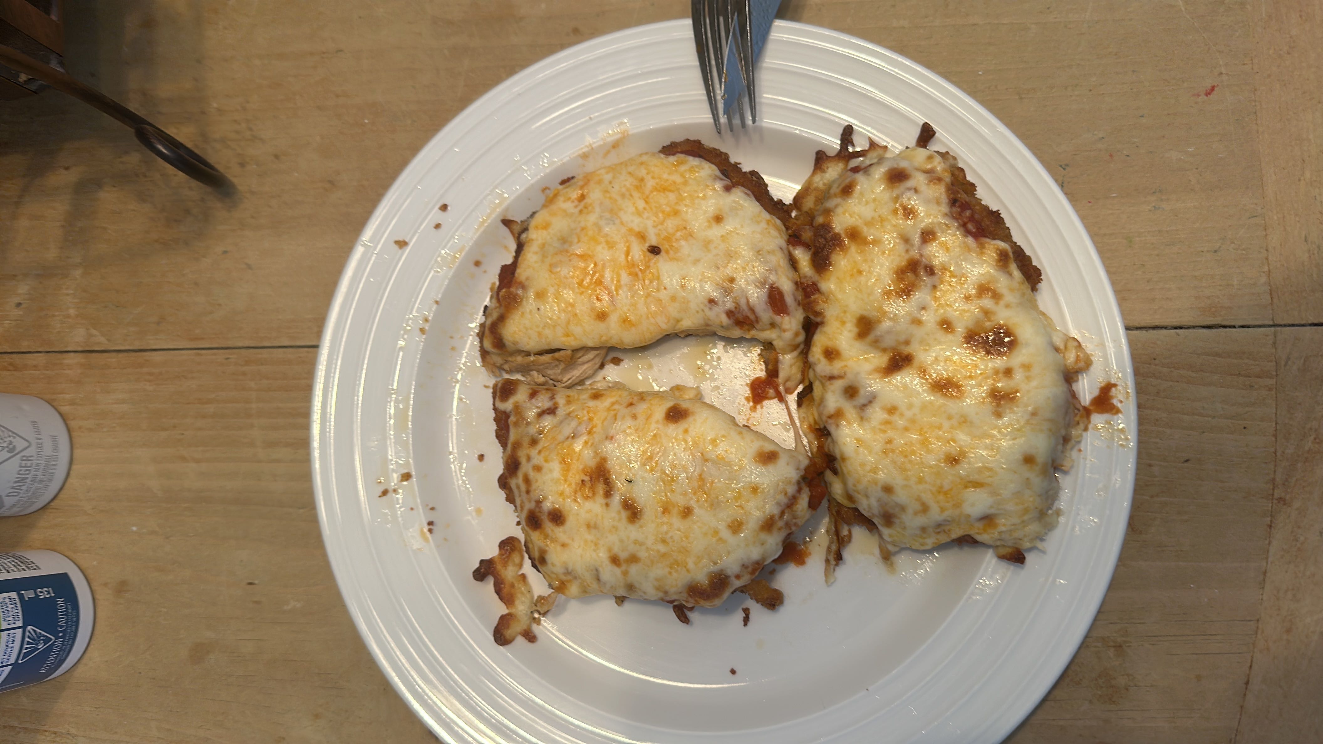 This dish appears to be chicken parmesan, featuring breaded chicken breast topped with tomato sauce and melted mozzarella cheese.