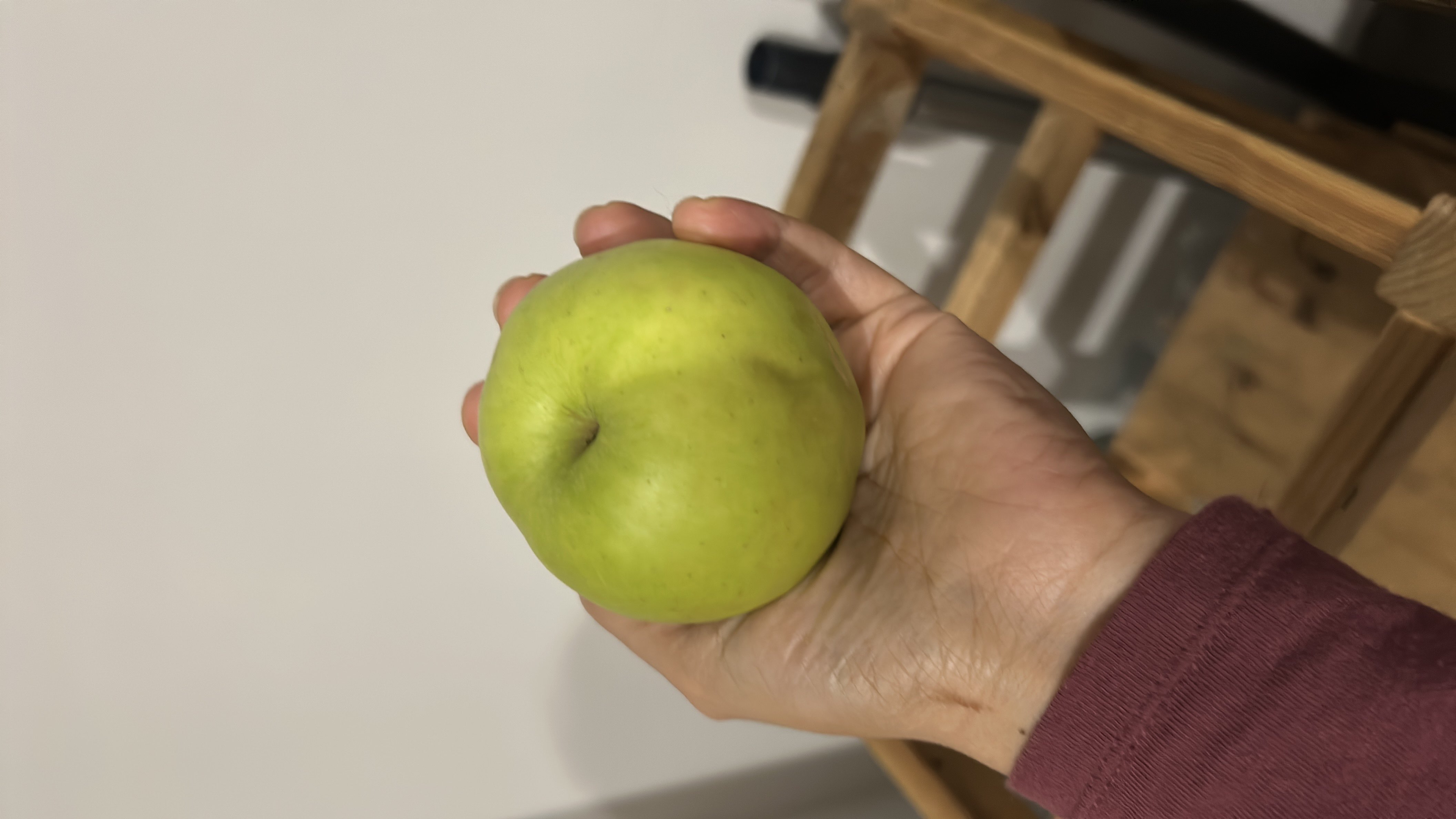 A green apple, a nutritious fruit rich in carbohydrates and low in fats and protein.