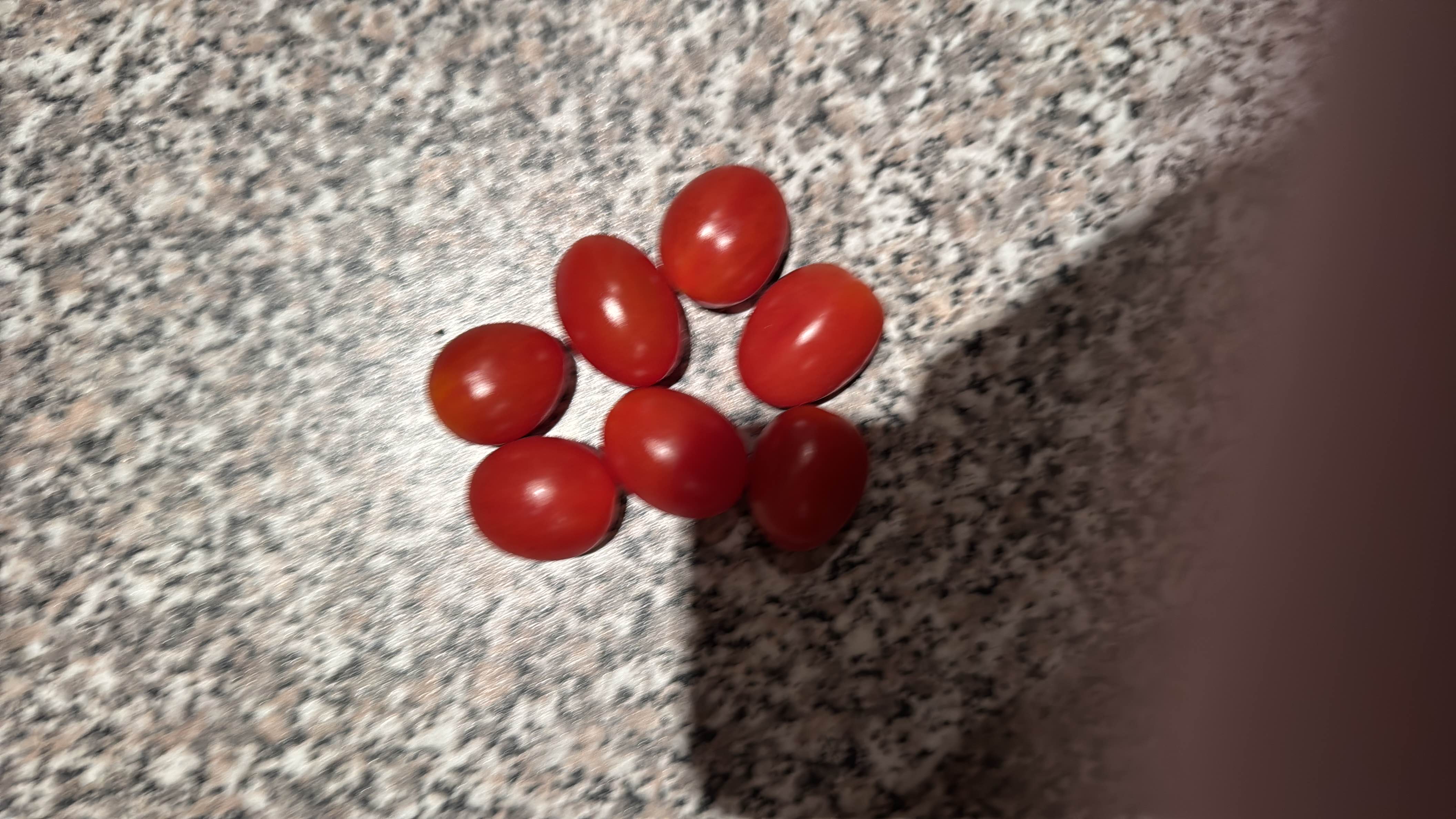 The image shows a group of cherry tomatoes, which are low in calories and rich in nutrients, making them a healthy snack option.