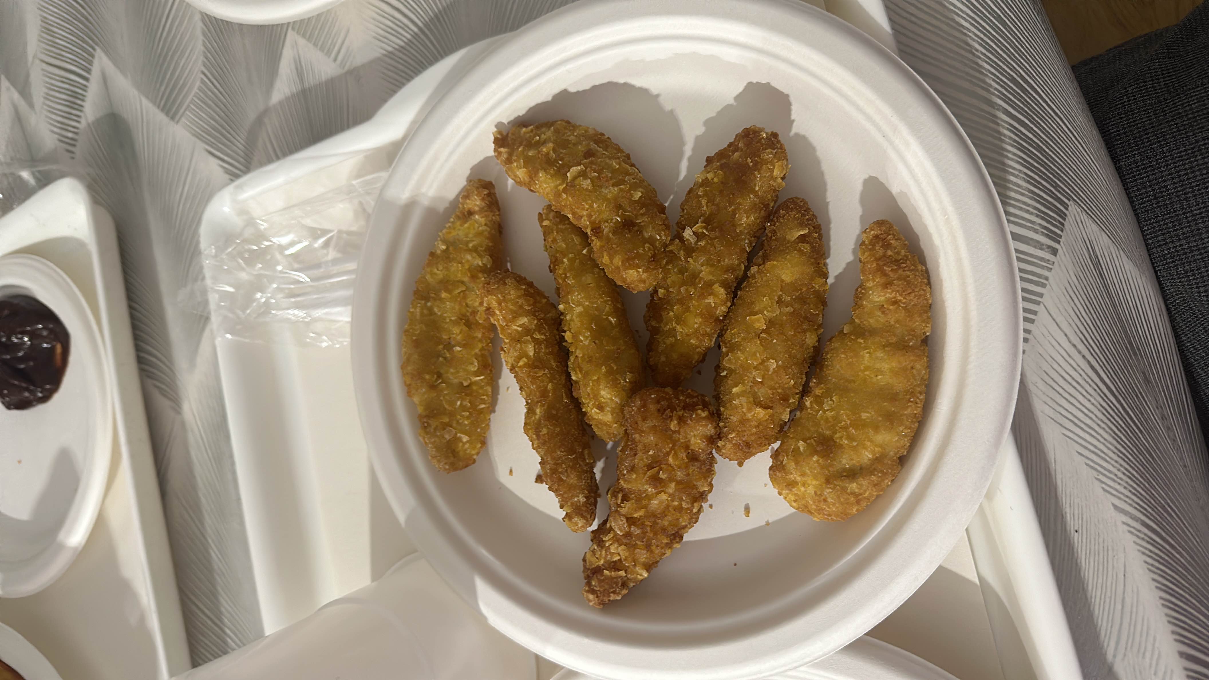 A plate of breaded chicken strips, likely fried, providing a moderate amount of calories, protein, and fats.