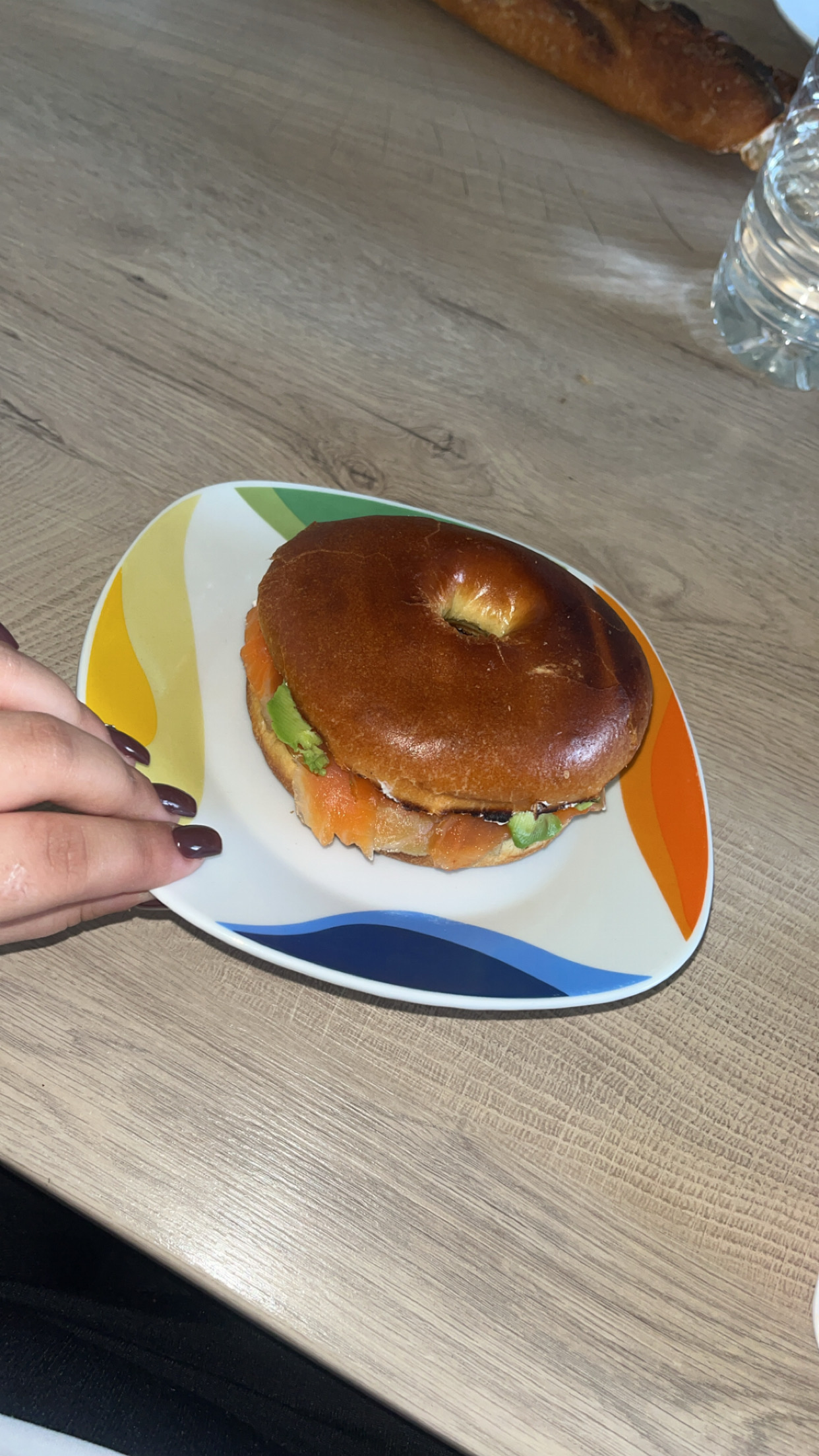 A bagel sandwich with smoked salmon and avocado, providing a balanced mix of carbs, protein, and healthy fats.