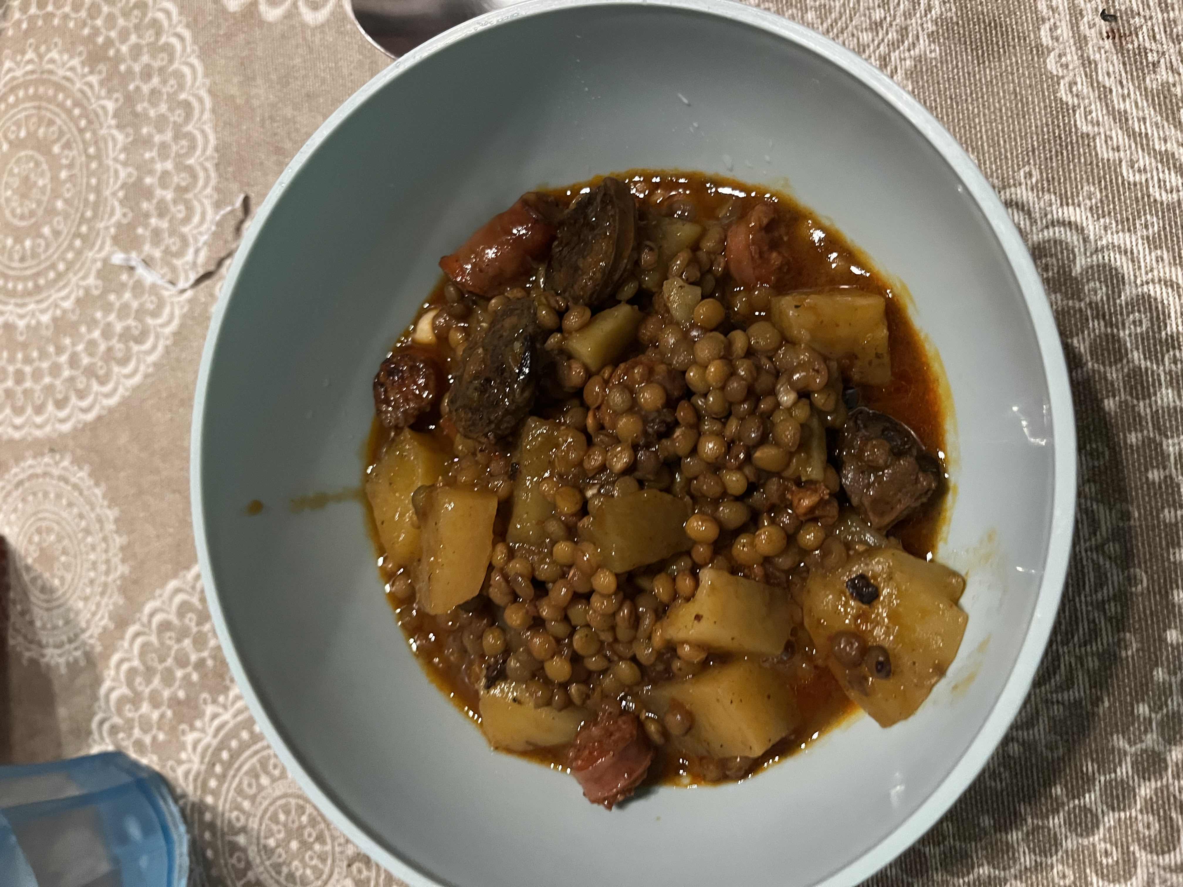 A hearty lentil stew with potatoes, beef, and carrots, providing a balanced mix of protein, carbs, and fats.