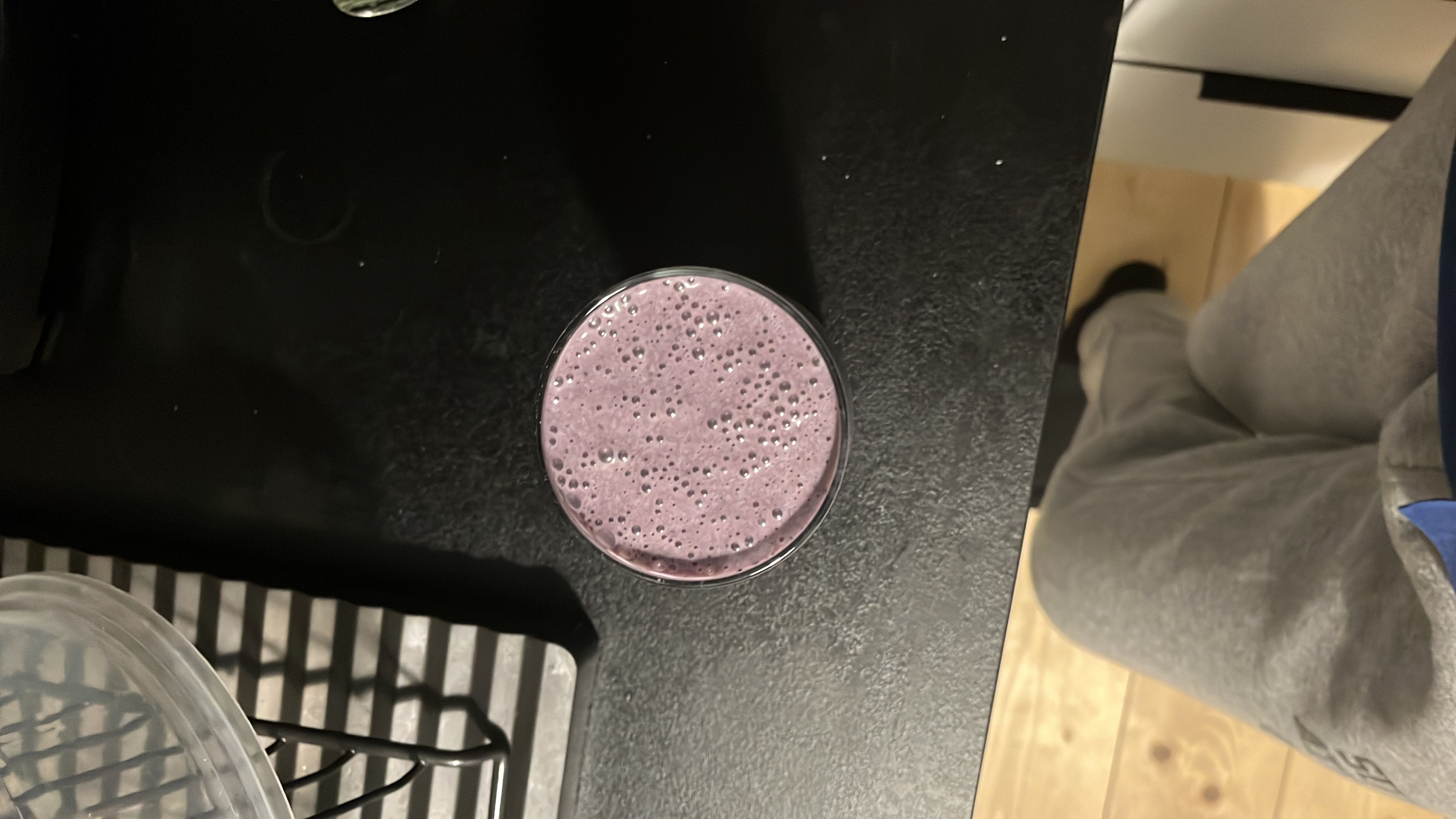 A blueberry smoothie made with banana and almond milk, providing a balanced mix of carbs, protein, and fats.